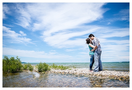 Couple kissing on a small island in Elk Rapids Michigan in Grand Traverse Bay
