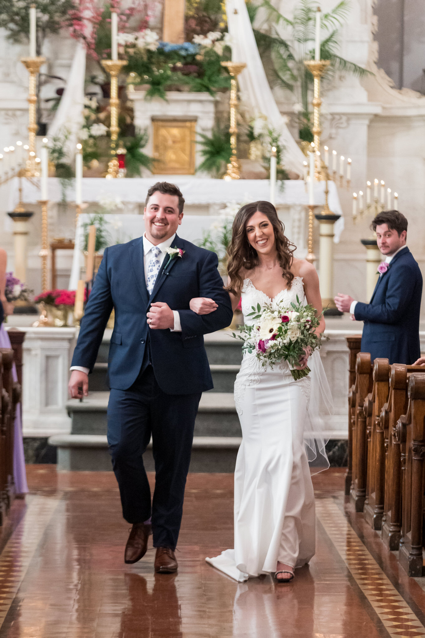 bride and groom walk down the aisle of Sts Peter and Paul Jesuit church in Detroit after being announced husband and wife