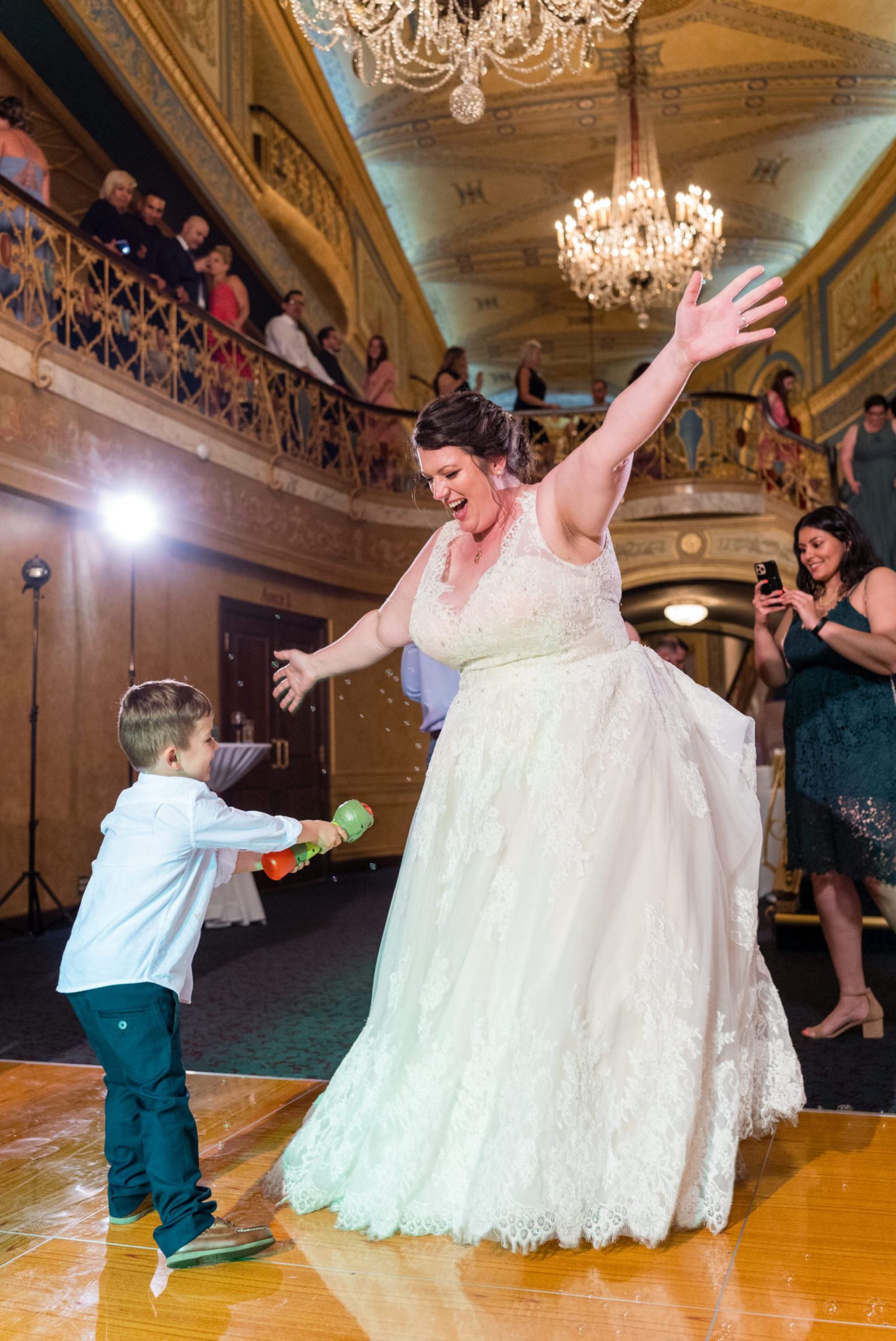 bride dancing with a young boy at the Detroit Opera House