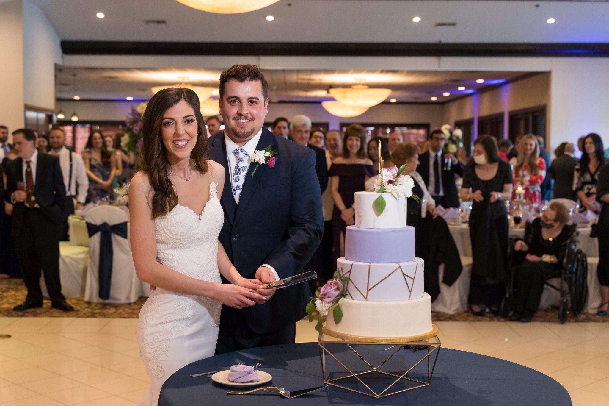 bride and groom cut their cake at Italian American Cultural Society Wedding reception