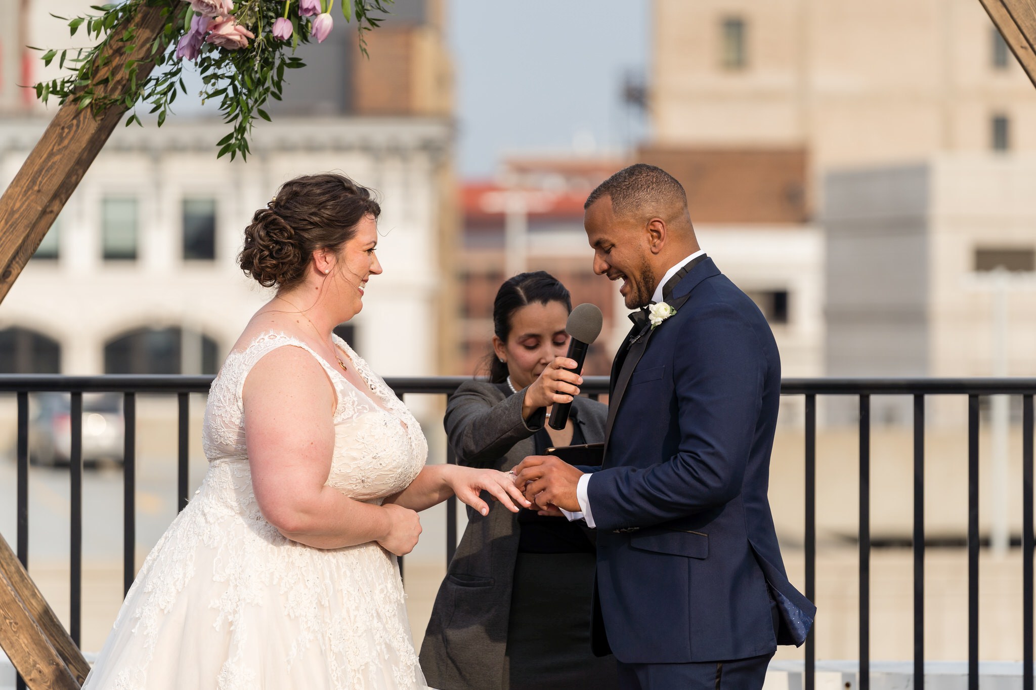 bride and groom exchange rings at their wedding at the Detroit Opera house