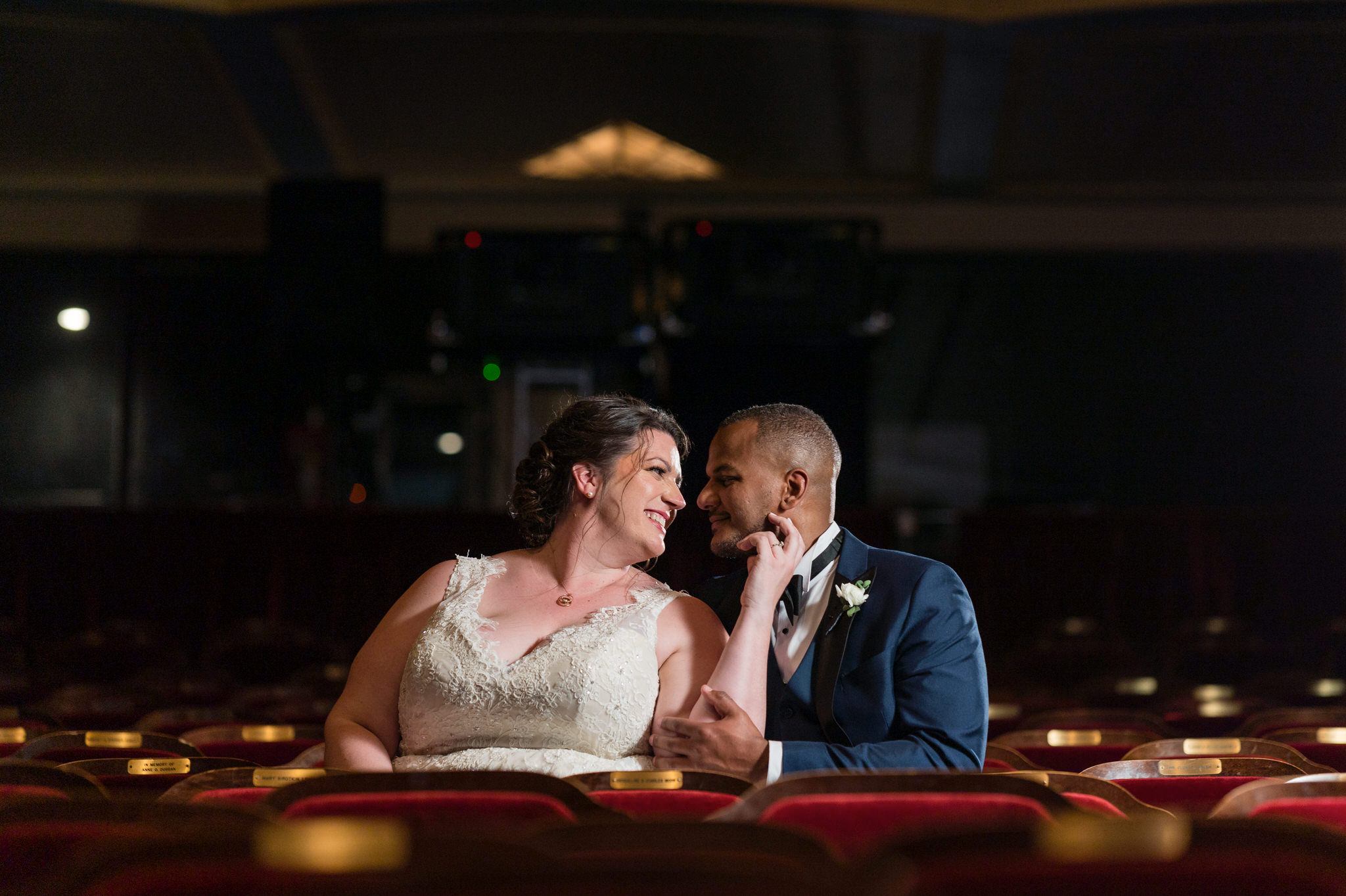 a bride and groom sit in the Detroit Opera house theatre