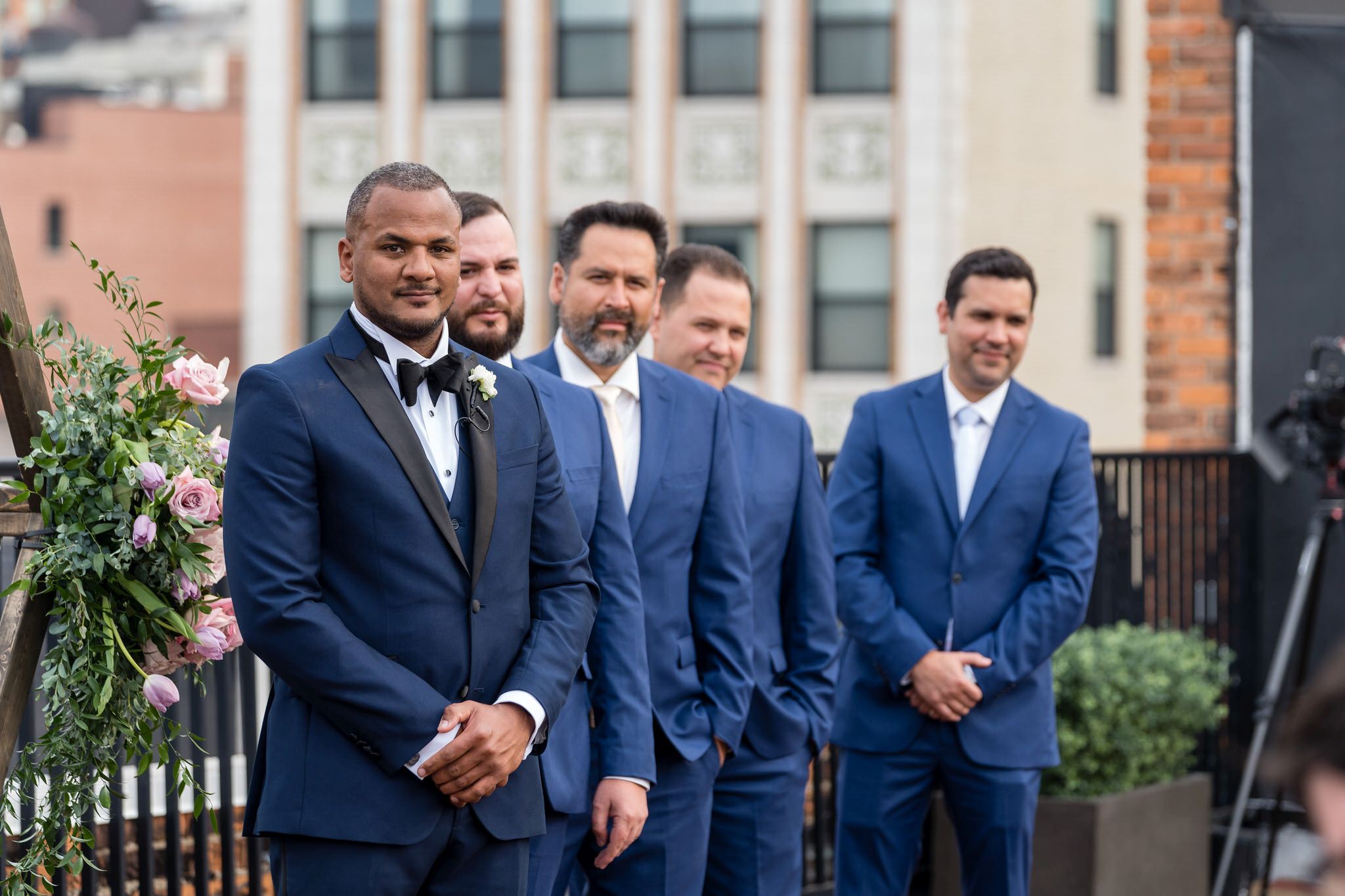 a groom and his groomsmen wait for the wedding ceremony to start
