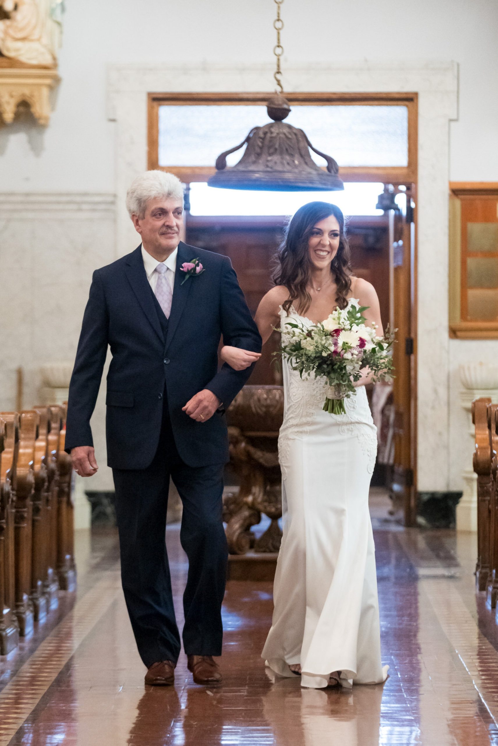 bride and her father walking down the aisle at Saints Peter and Paul Jesuit church in Detroit, MI