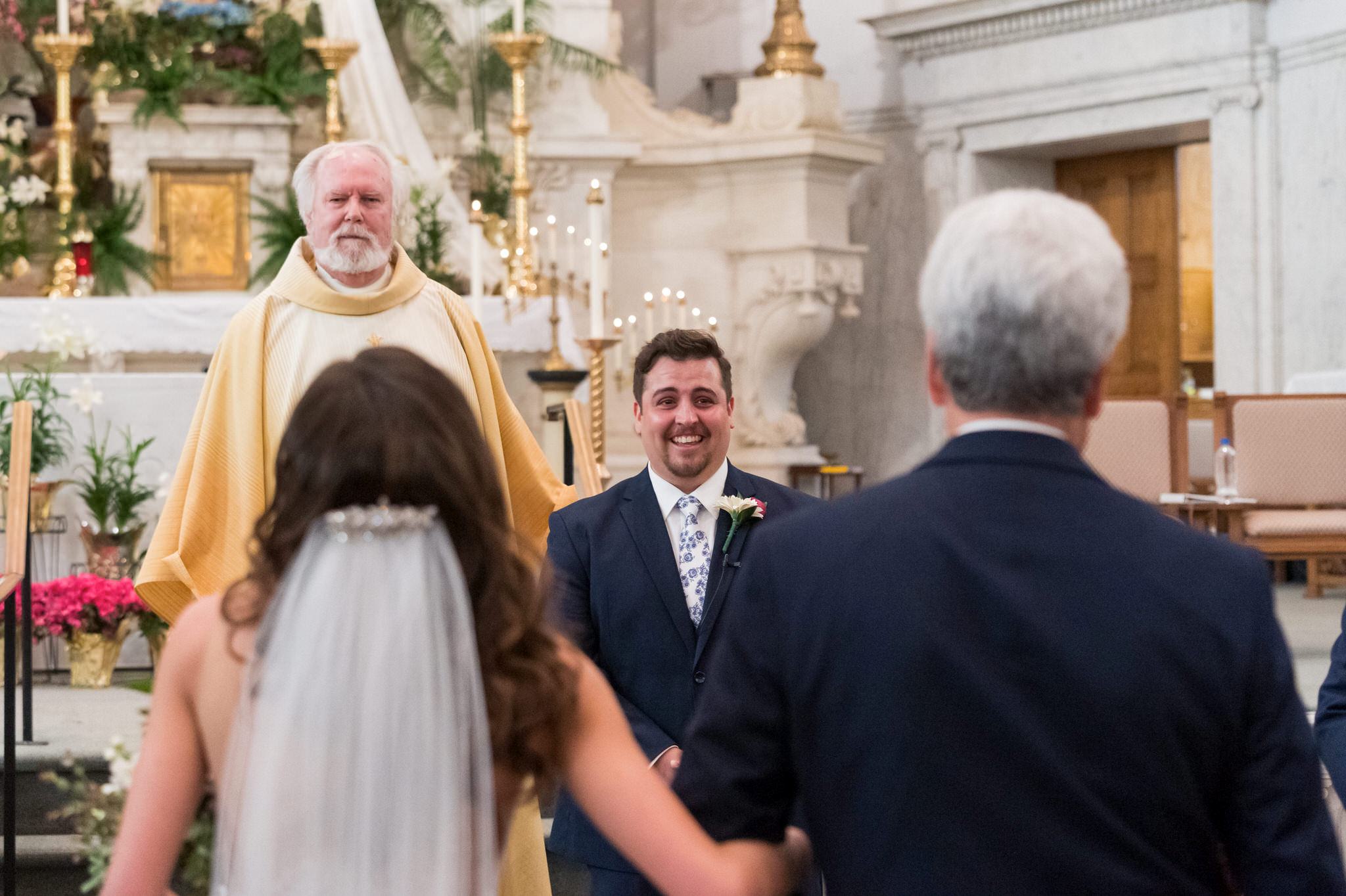 groom seeing his bride for the first time at Saints Peter and Paul Jesuit Church in Detroit