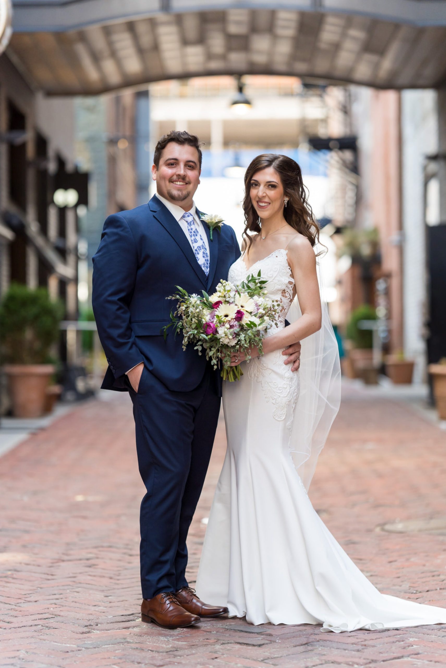 bride, holding a bouquet, and groom at Parker's Alley in Detroit Michigan