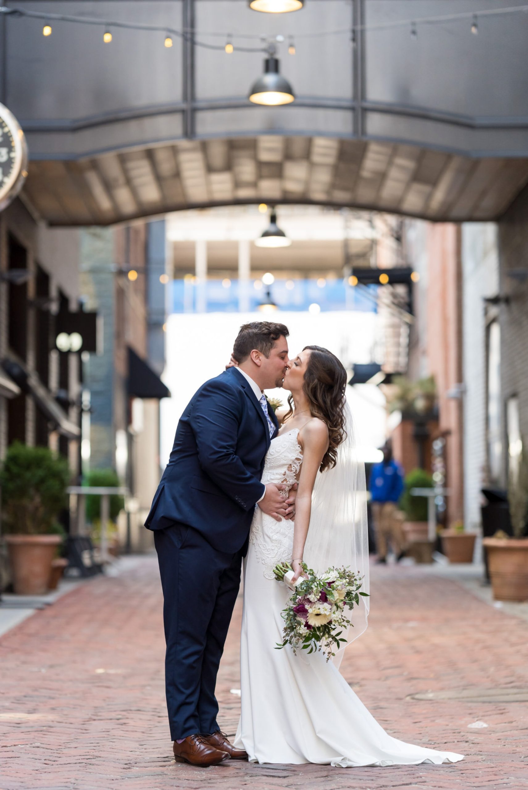 bride and groom share a kiss in Parker's Alley Detroit