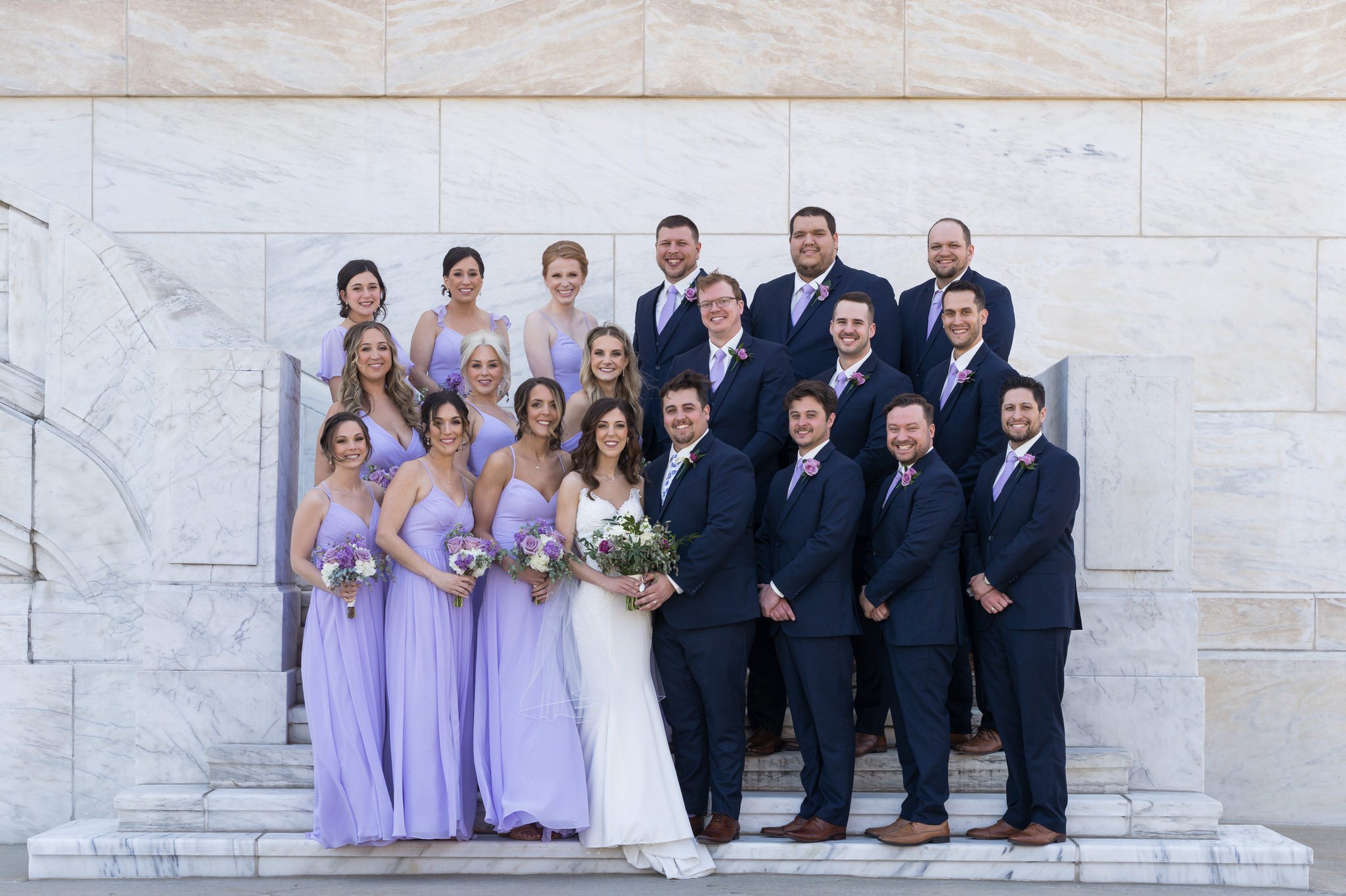 bridesmaids wearing a pastel purple and groomsmen wearing blue suits at the Detroit Institute of Arts