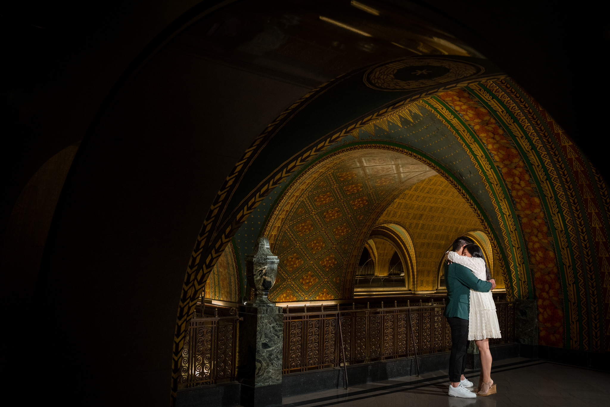 couple hugs after marriage proposal at Detroit's Fischer Building