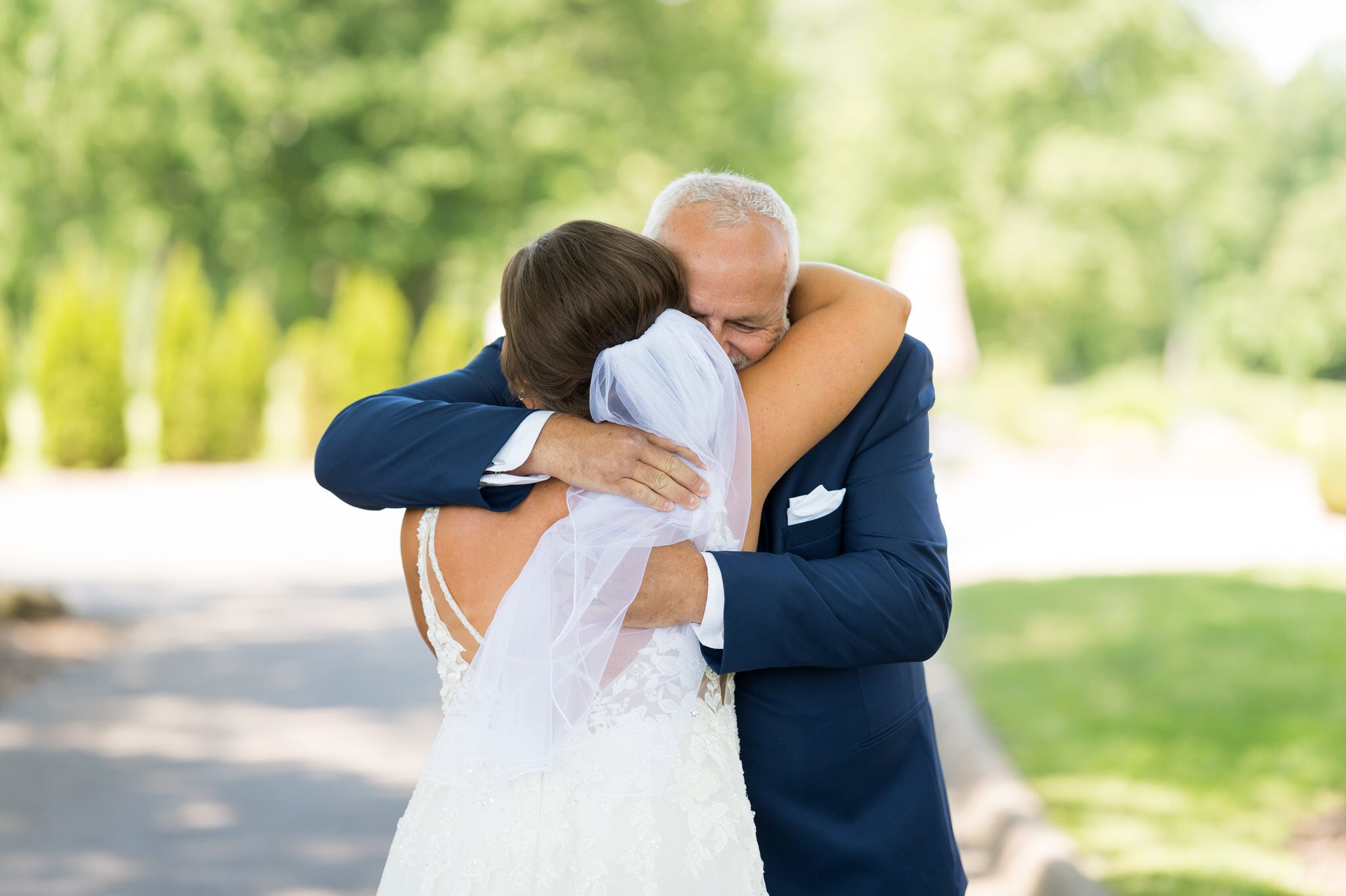 a dad shares a hug with his daughter on her wedding day