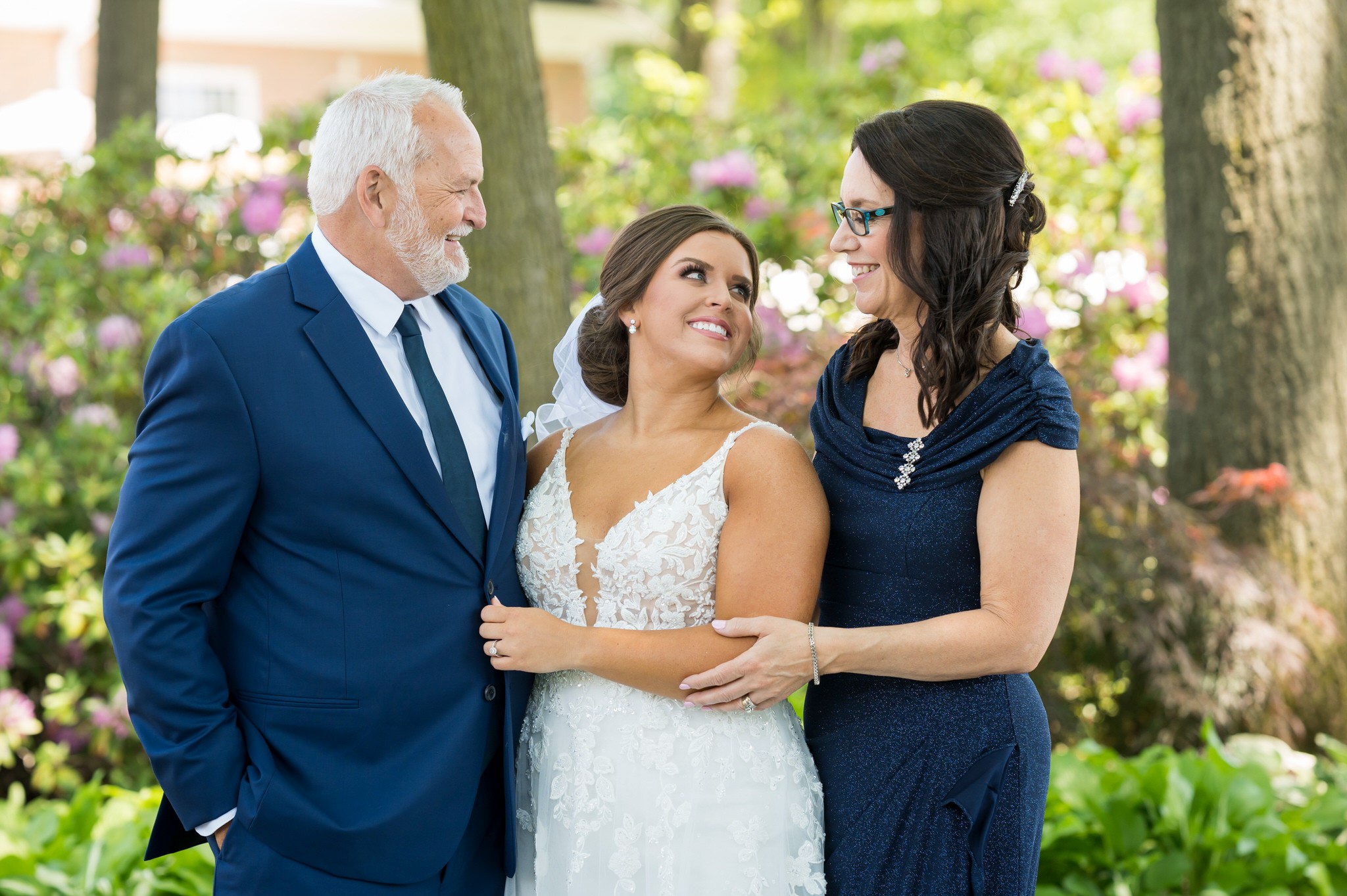 parents look lovingly onward at their daughter bride at a wedding at Cherry Creek Golf Club