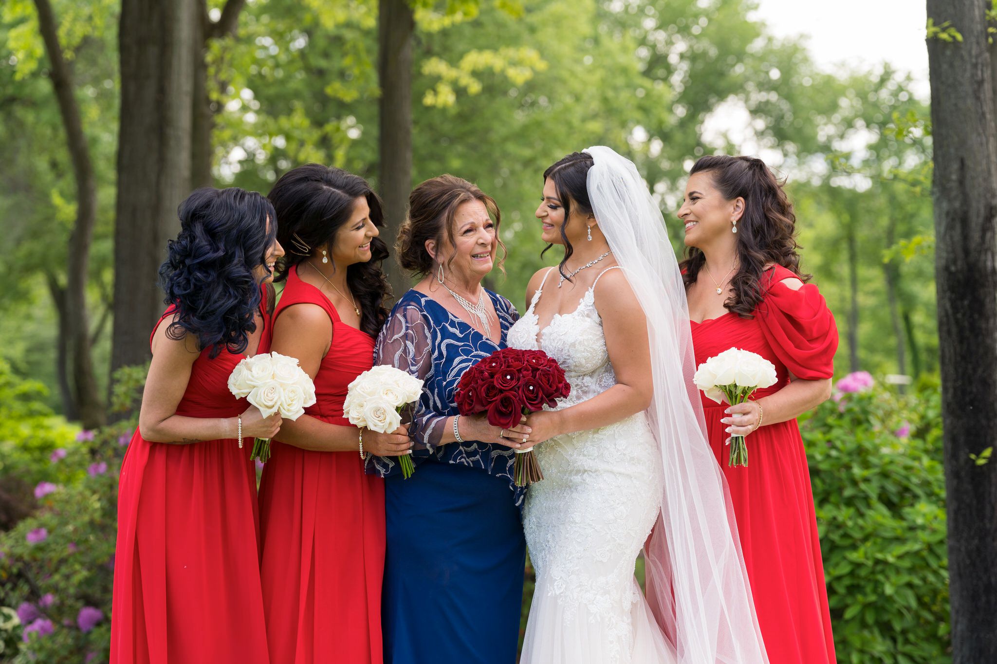 a mother and her daughters hug  at a wedding
