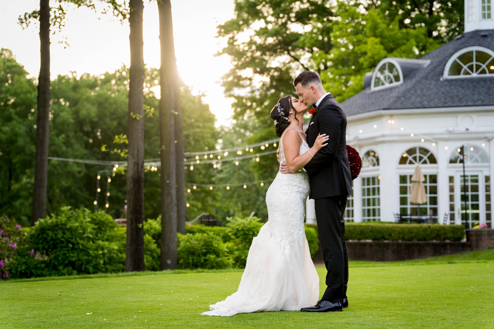 a bride and groom embrace and kiss during the golden hour at their Cherry Creek Golf Club wedding