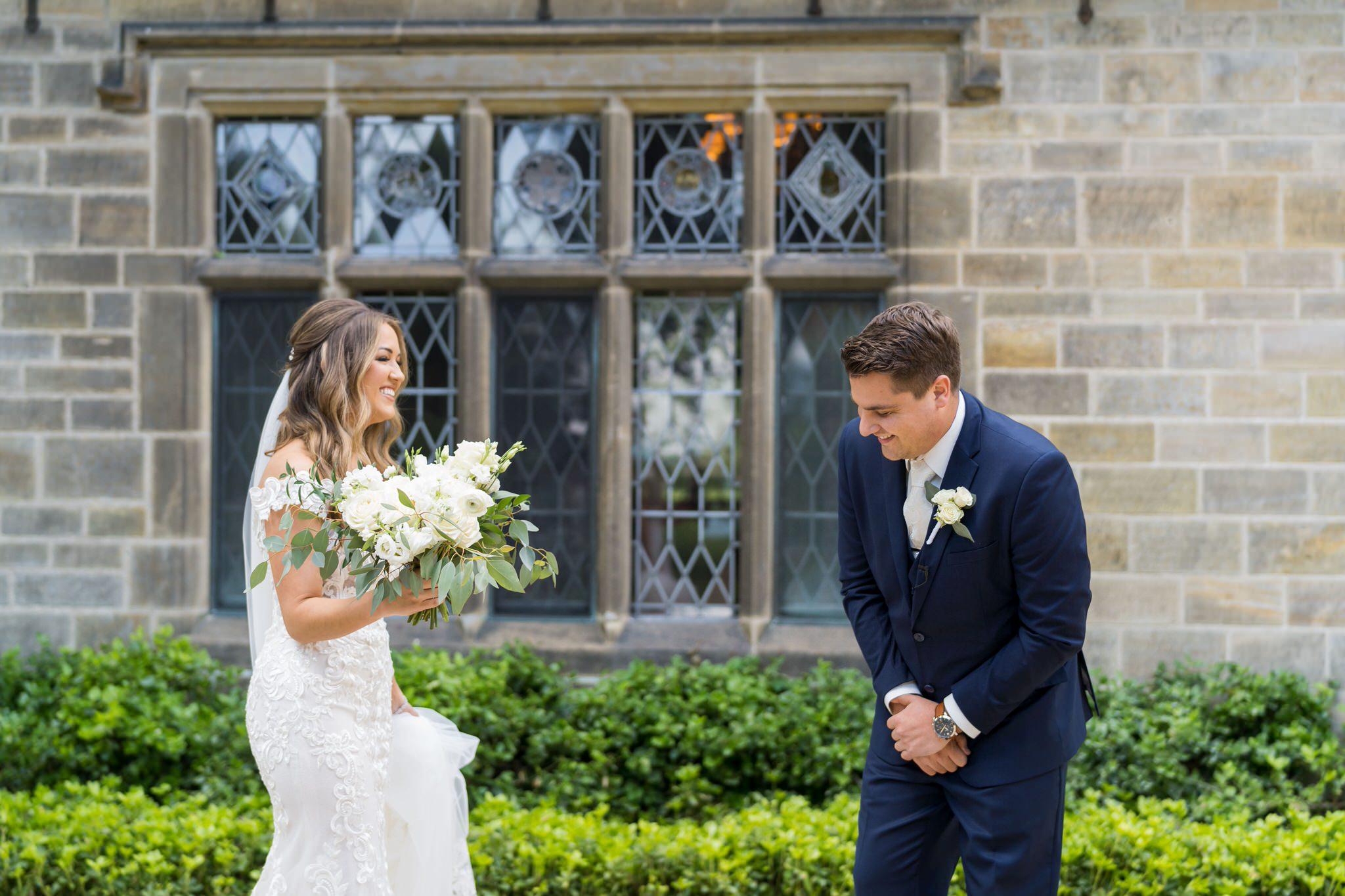 Groom sees the bride for the first time, a first look, and reacts, at the Edsel Ford House