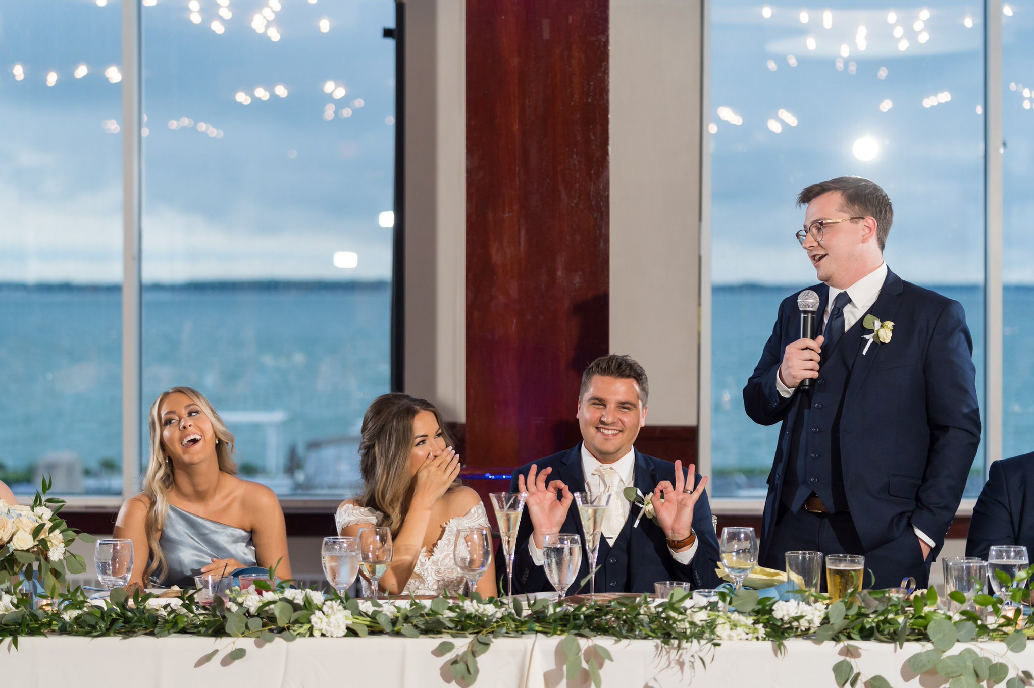 bride and groom laugh during their MacRay Harbor wedding reception
