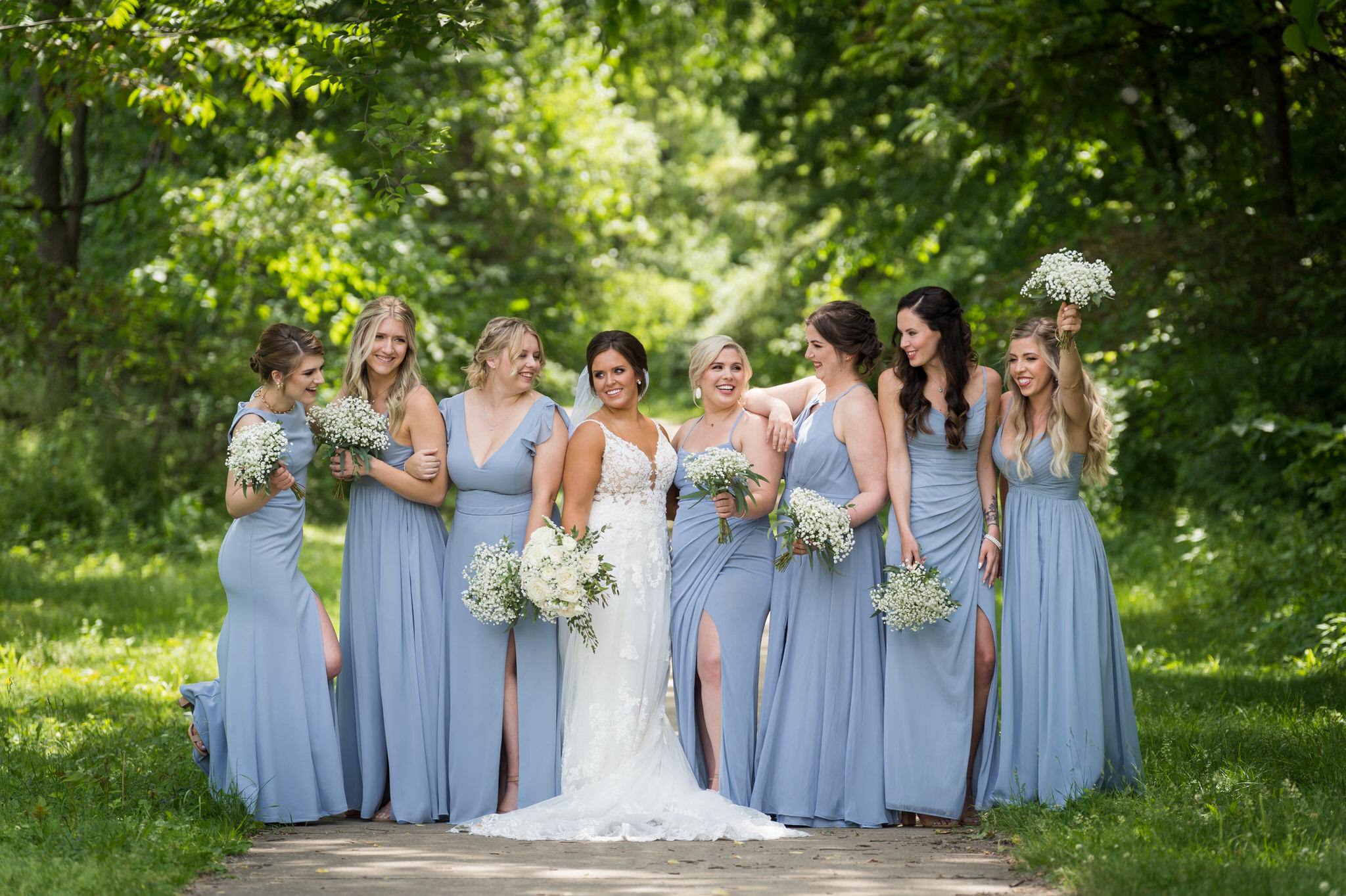 bridesmaids laugh together wearing light blue dresses at a wedding at Van Hoosen Museum 