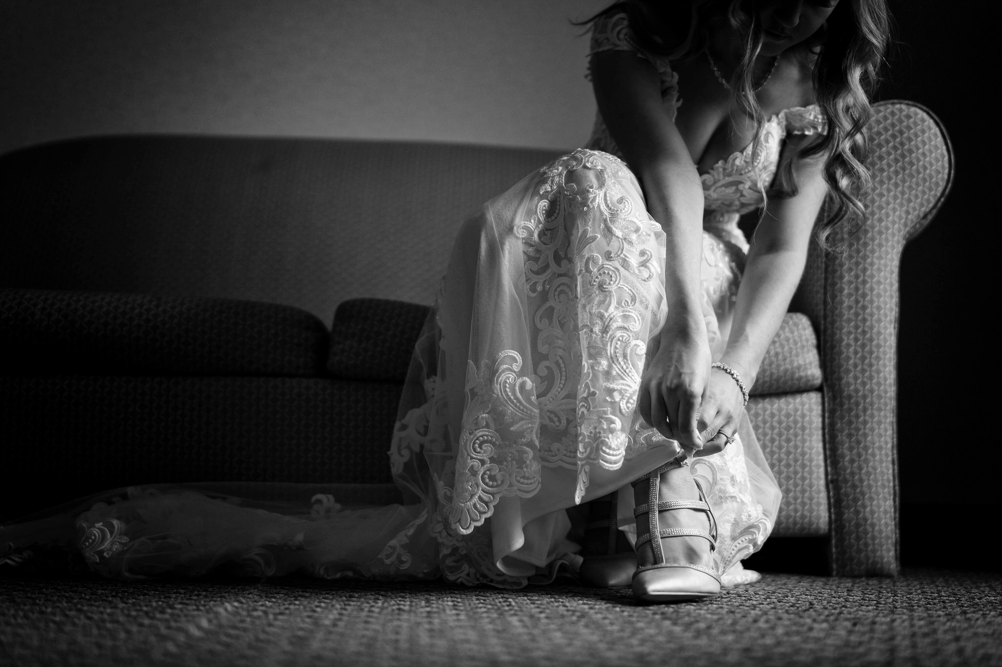 a close up of shoes being put on by a bride
