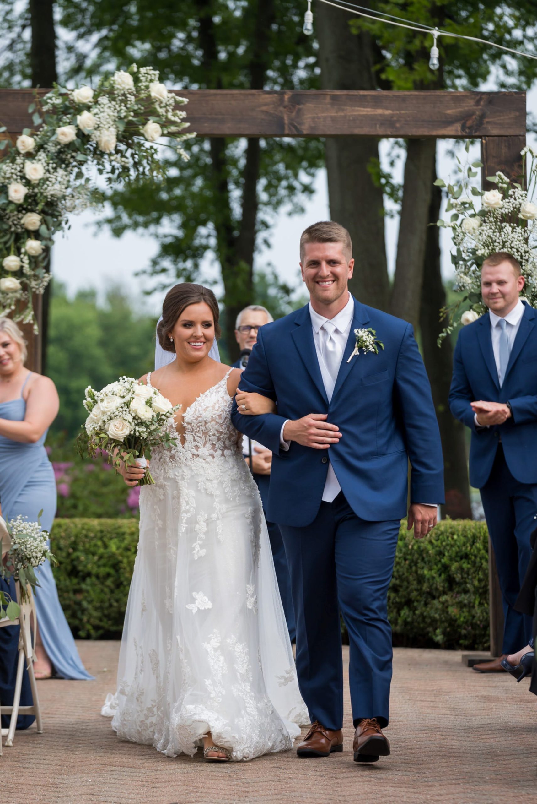 bride and groom walk down the aisle at their wedding at Cherry Creek Golf Course