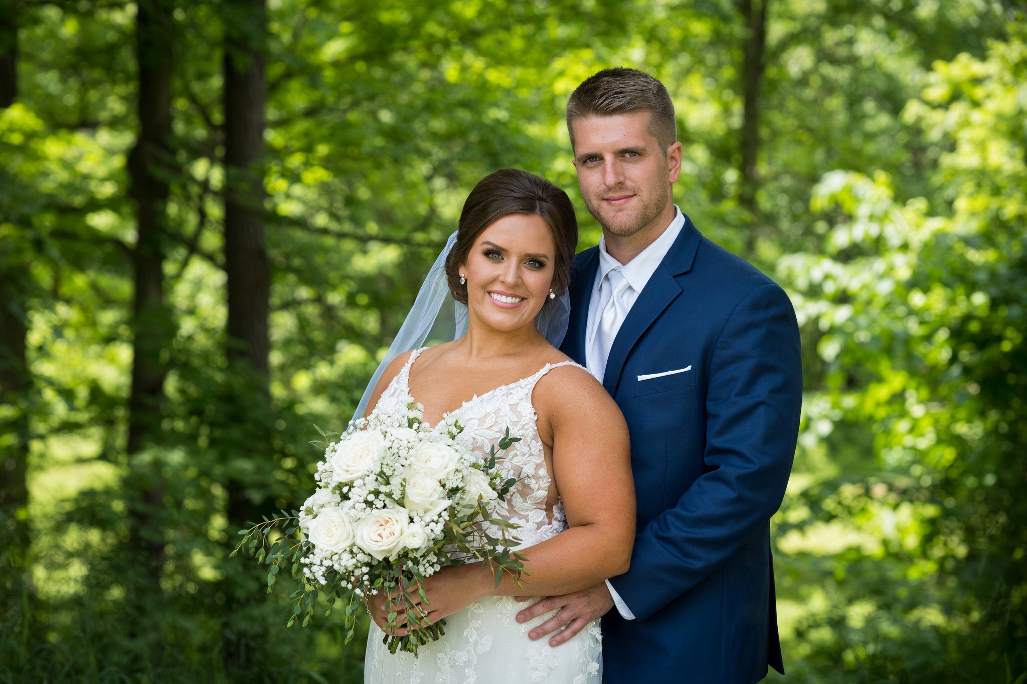a bride and groom smile during a portrait at their wedding at Van Hoosen Museum 
