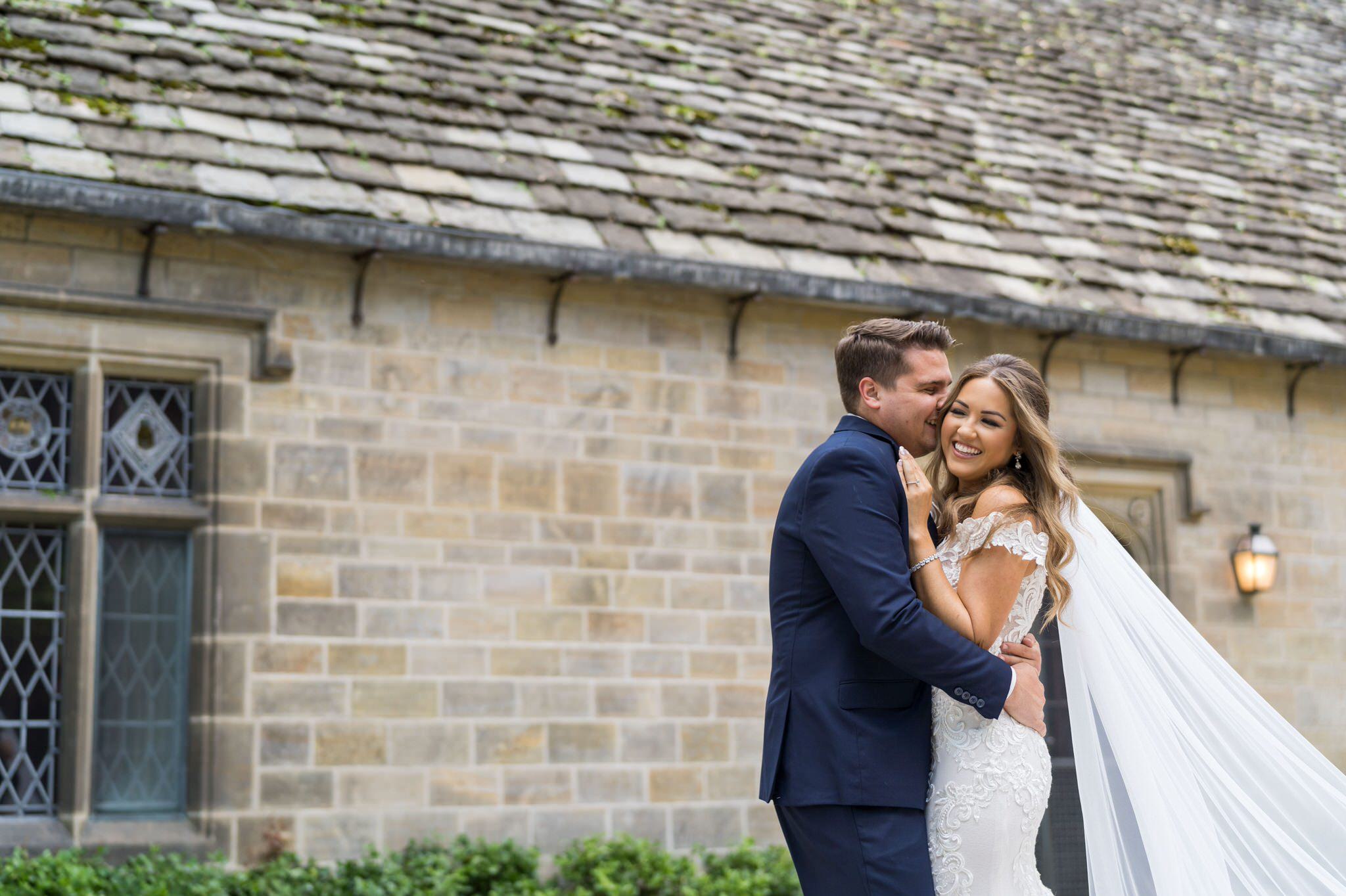 bride and groom embrace and laugh at the Edsel Ford House