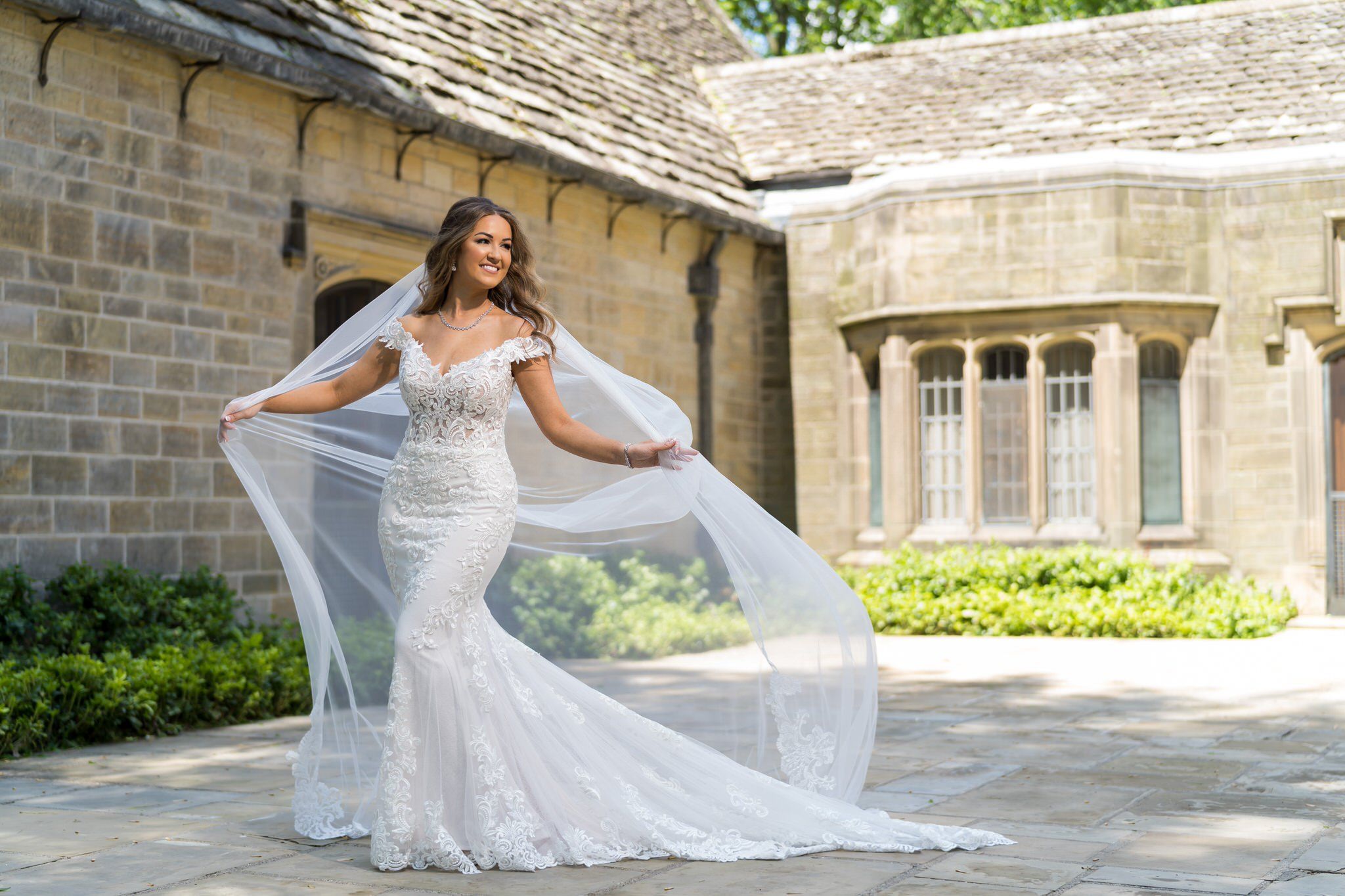 Bride poses while holding her veil at the Edsel Ford house