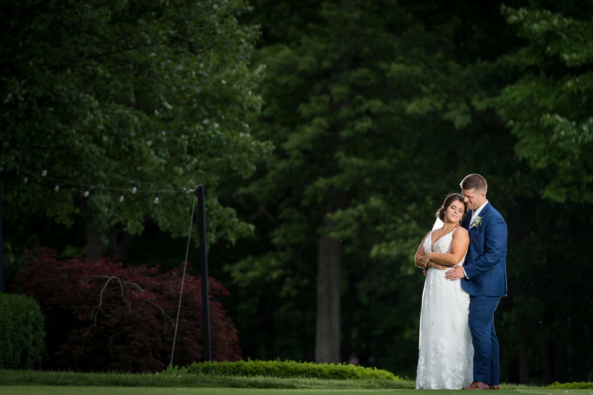 bride and groom hold each other at their wedding at Cherry Creek Golf Course