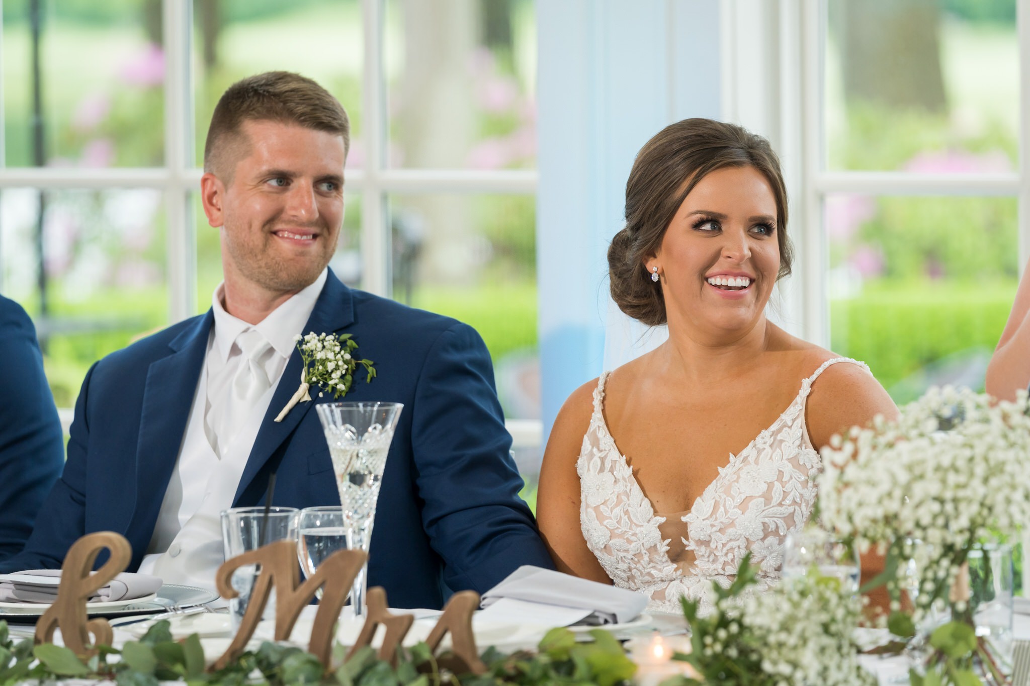 the bride and groom react to a speech at their wedding at Cherry Creek Golf Course