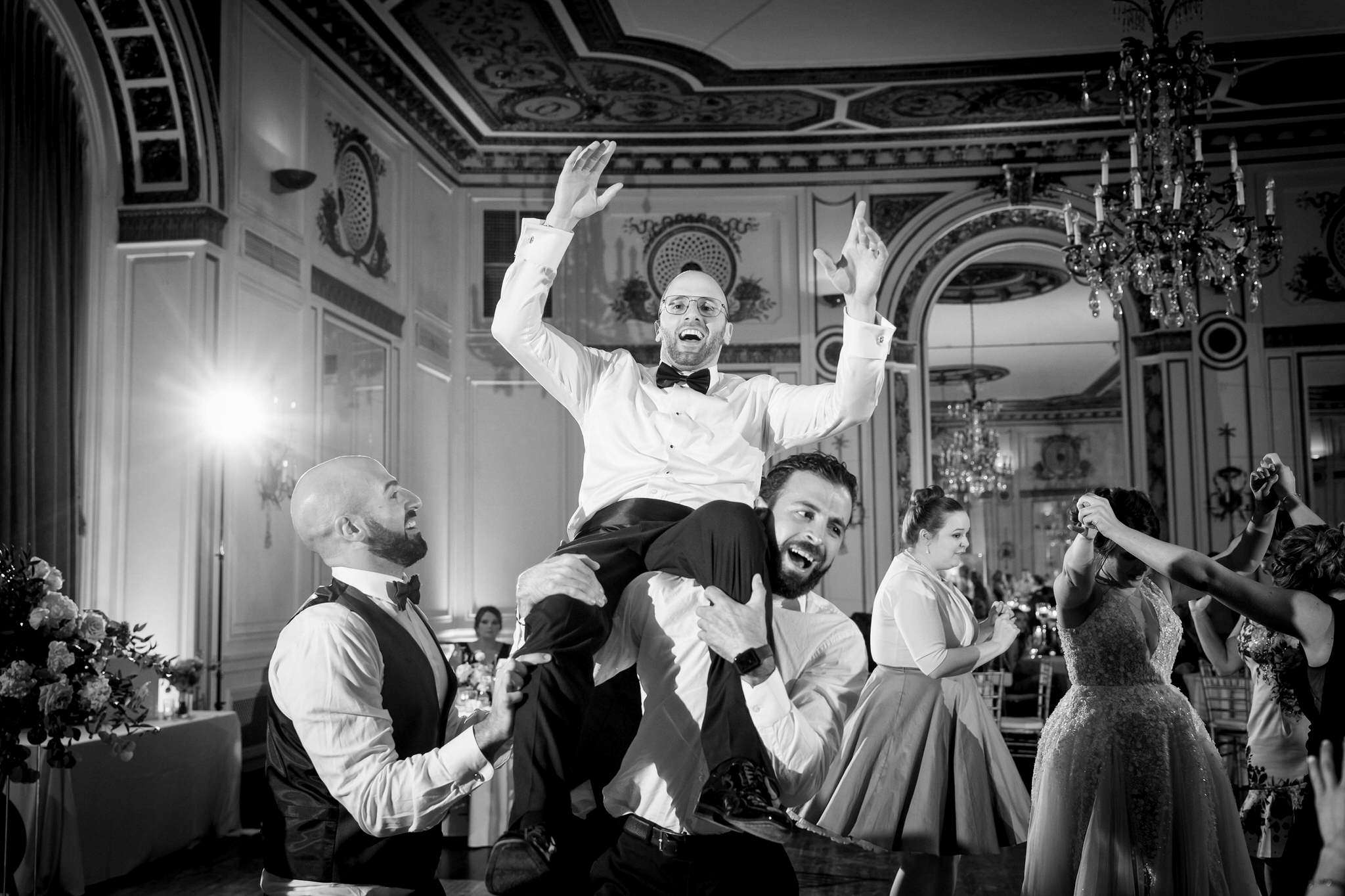 groom is hoisted on guests shoulders during a Colony Club wedding 