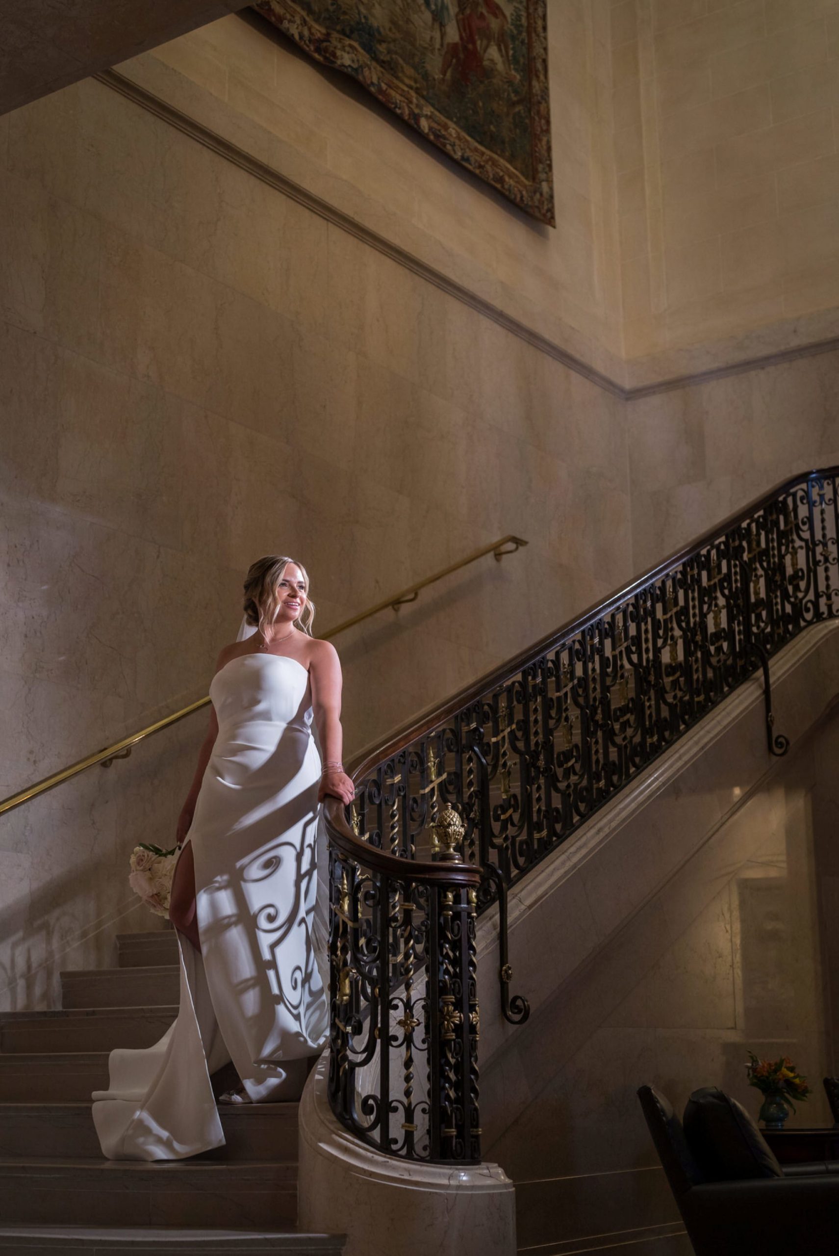 bride walks down the staircase at the Detroit Athletic Club
