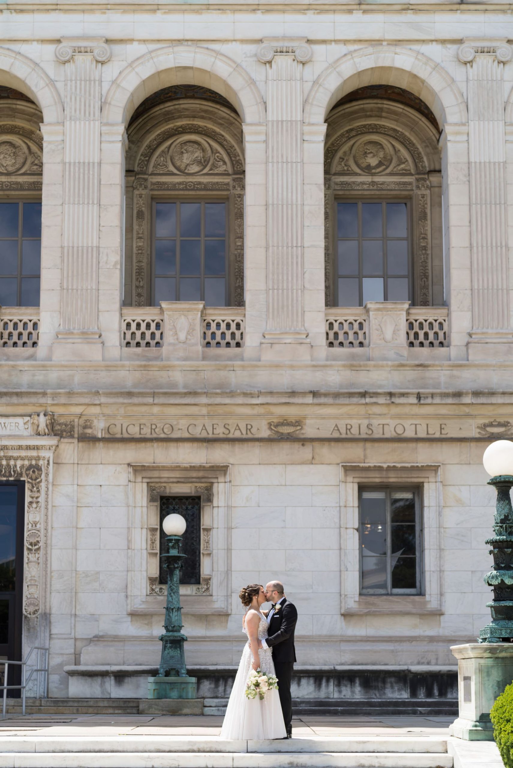 bride and groom kiss on Detroit Public Library steps