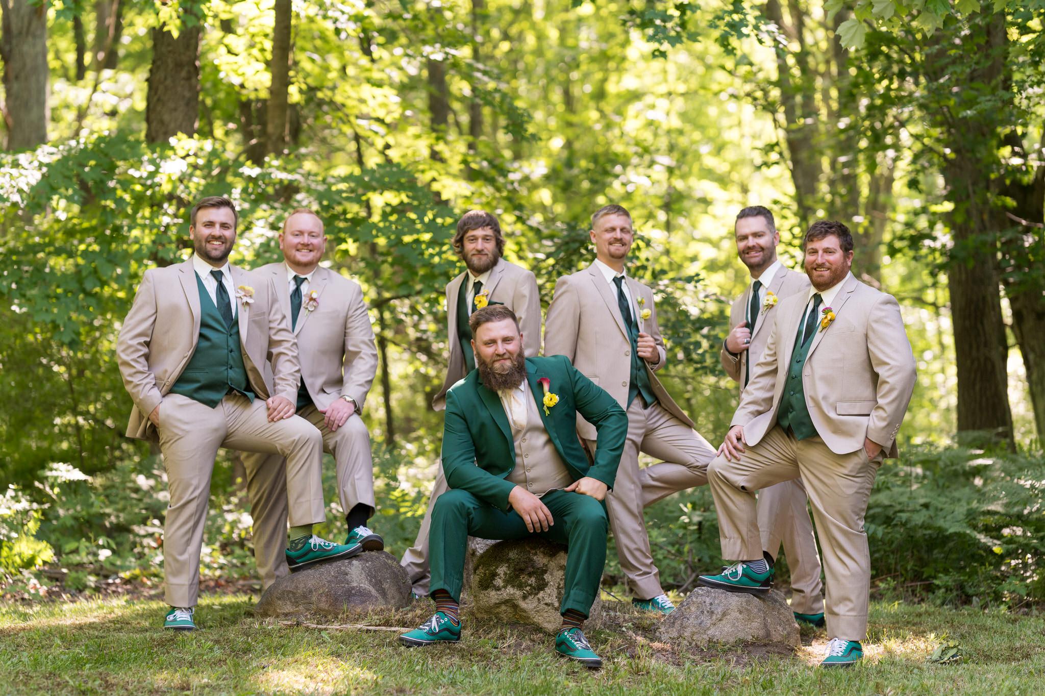 groomsmen pose in the woods at an Electric Forest wedding