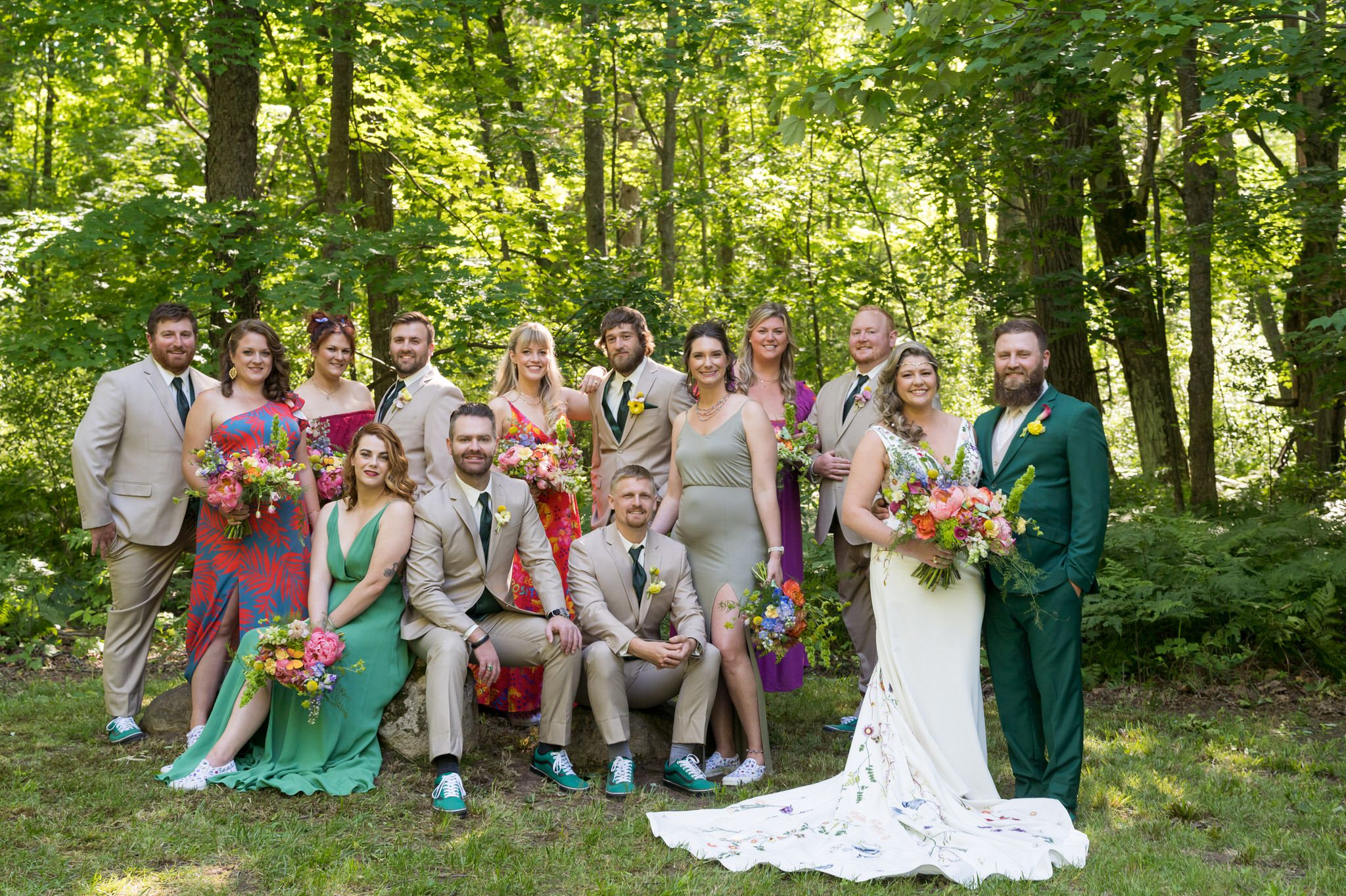 bridal party poses in the woods at an Electric Forest wedding