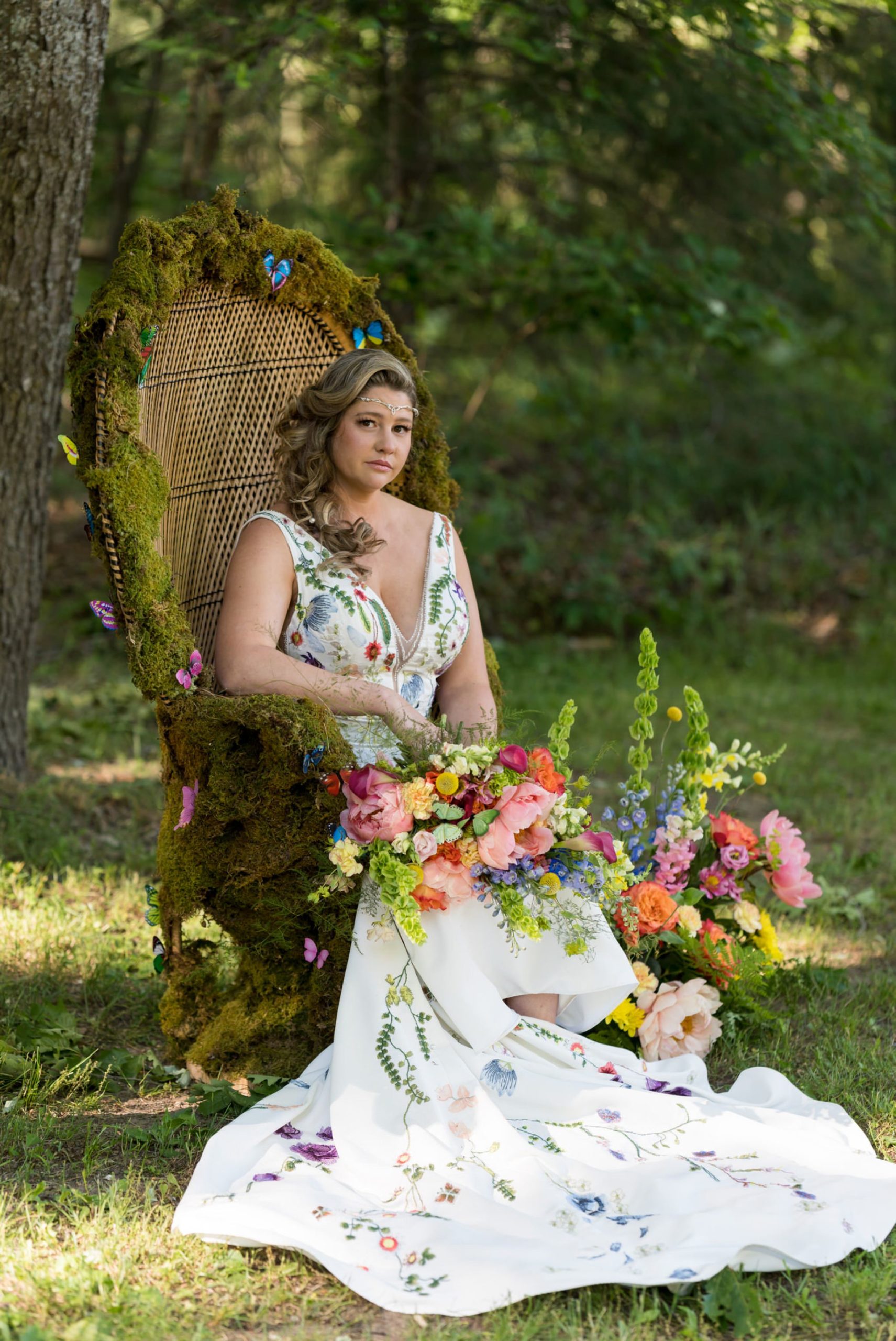 a bride sit in a moss and flower covered wicker chair