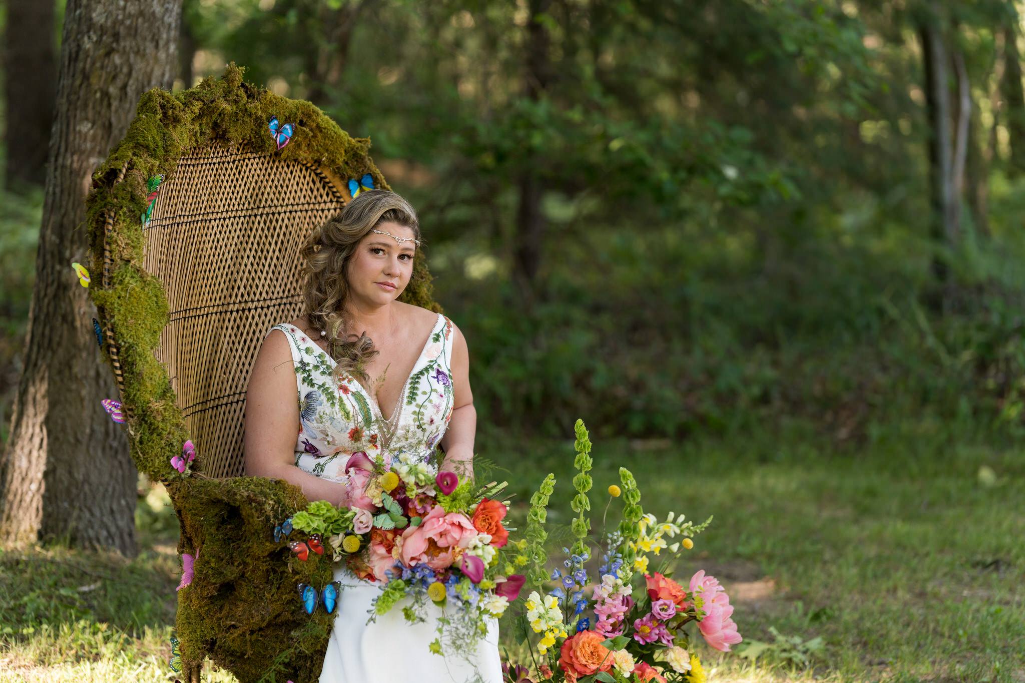 a bride sit in a moss and flower covered wicker chair