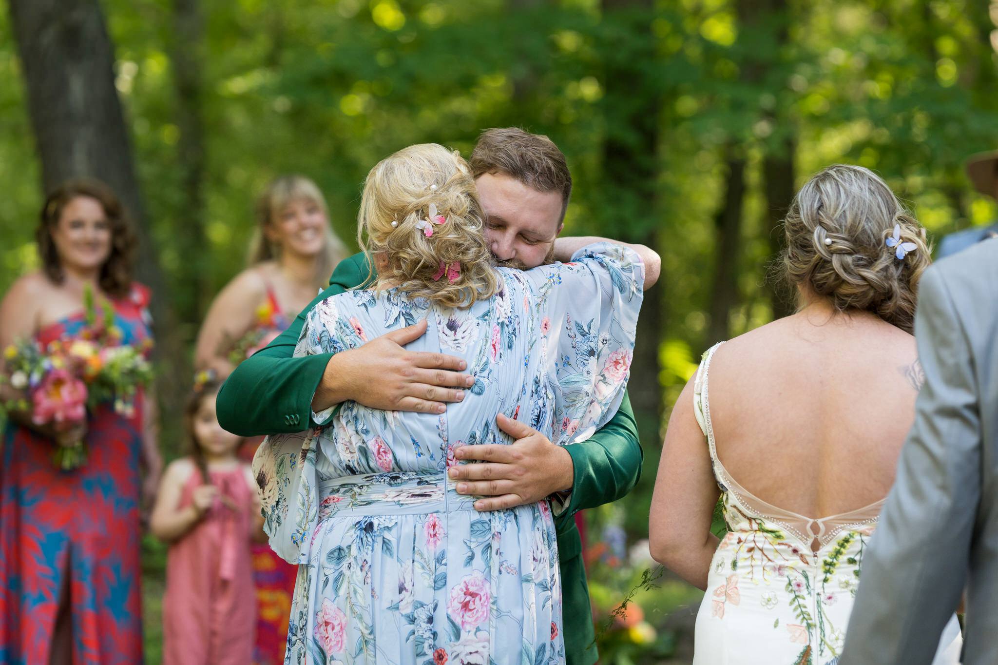 the groom hugs the mother of the bride