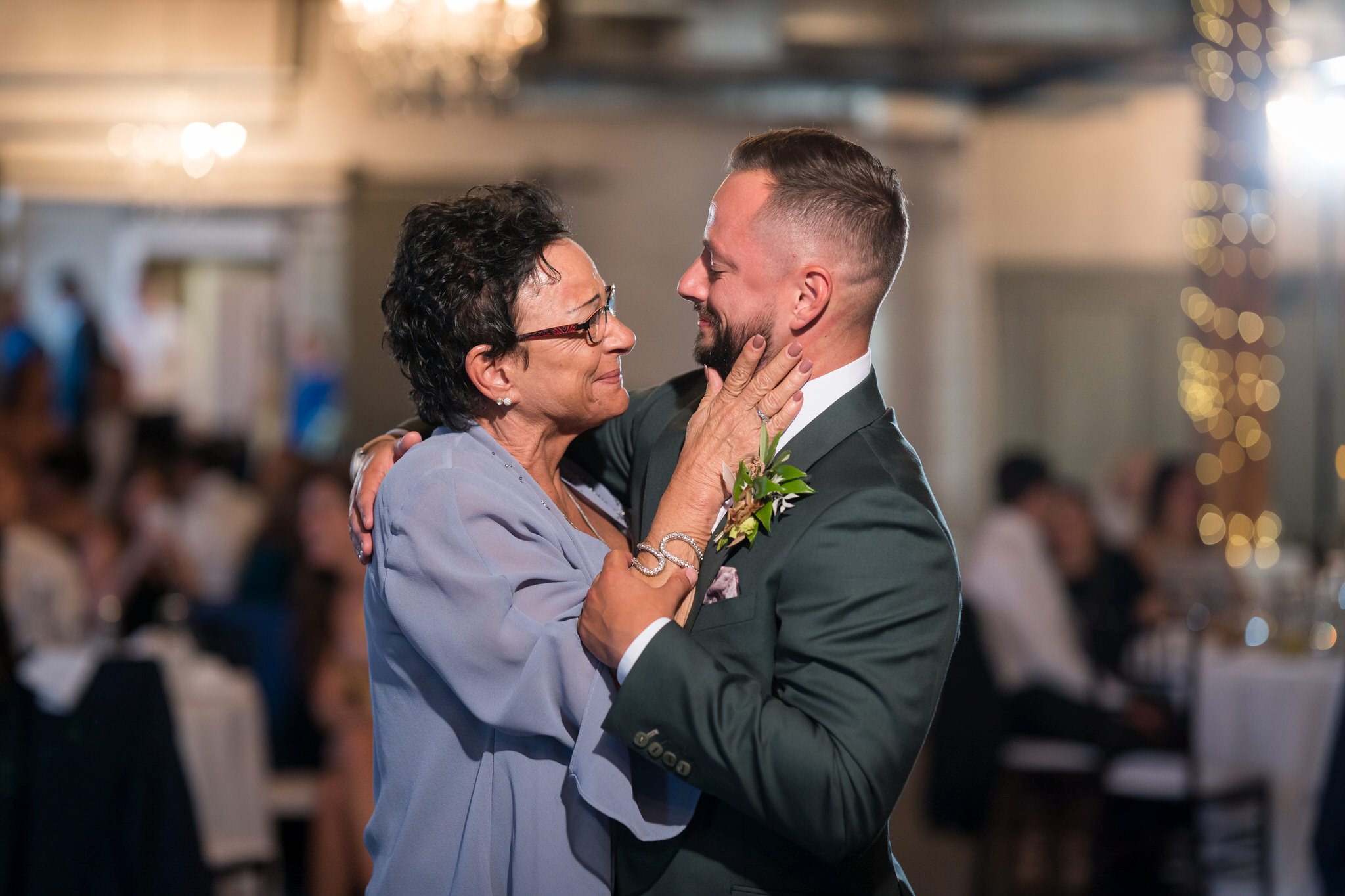 mother and son share a formal dance at a Holly Vault wedding reception