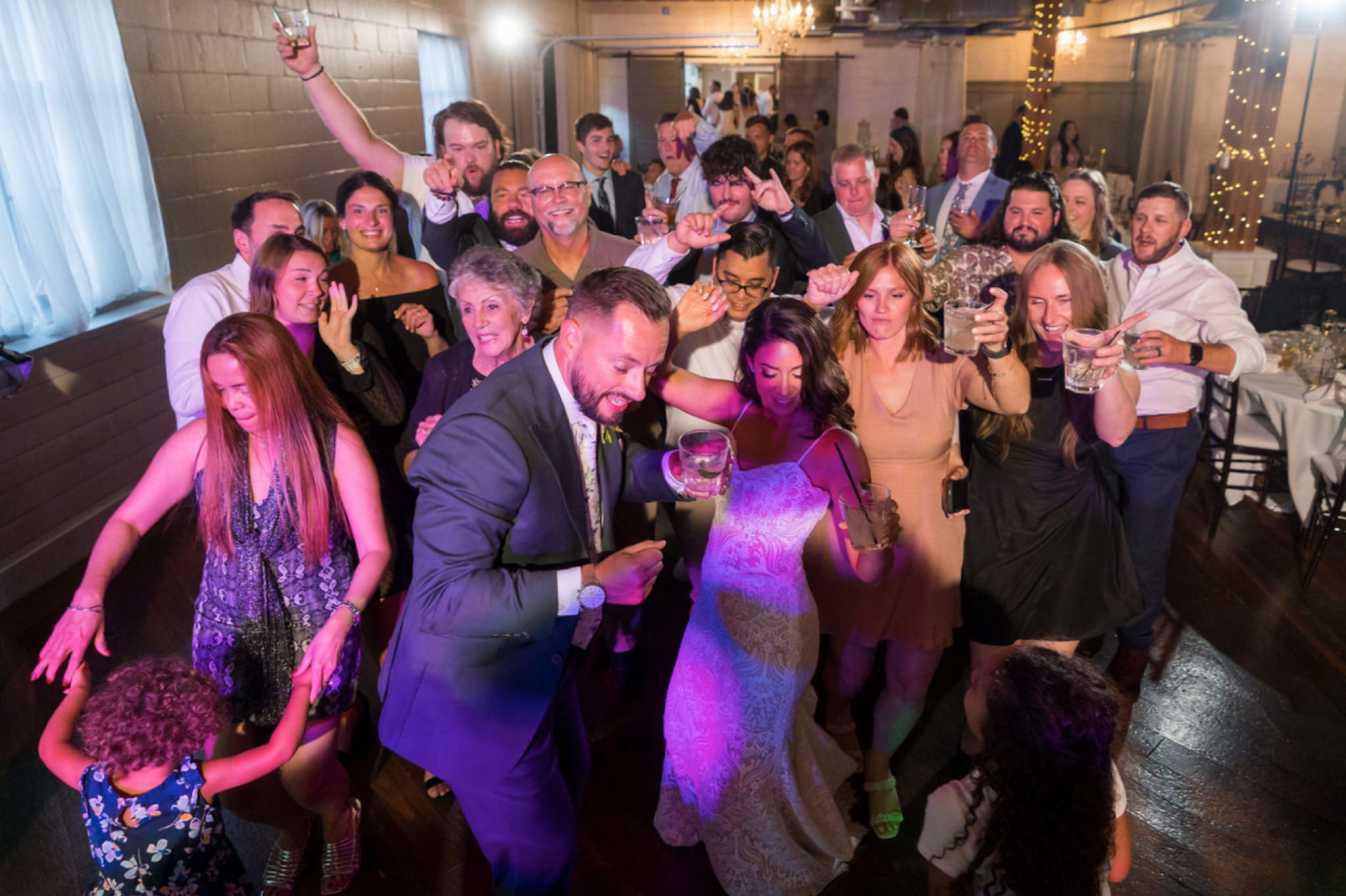 guests dance on a packed dance floor at a Holly Vault wedding reception