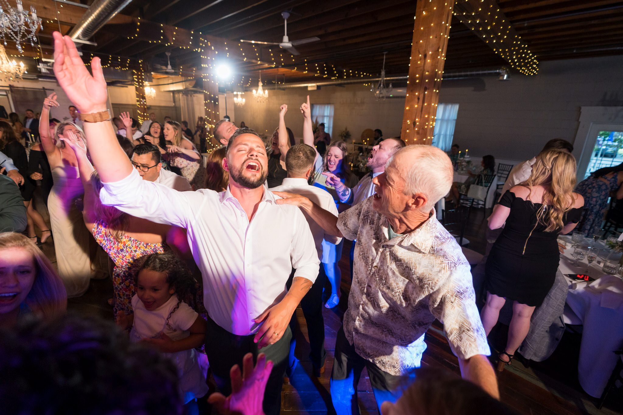 guests dance on a packed dance floor at a Holly Vault wedding reception