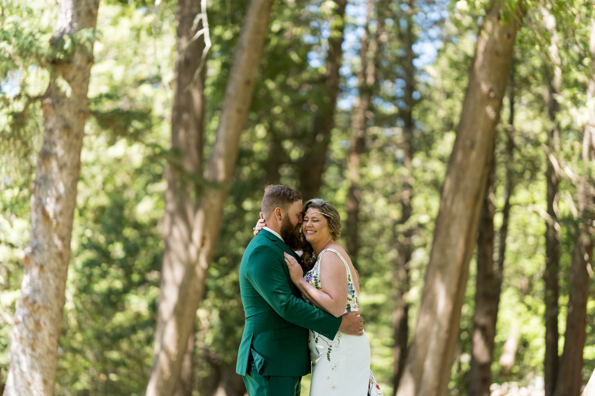 bride and groom embrace at their first look on Hubbard Lake