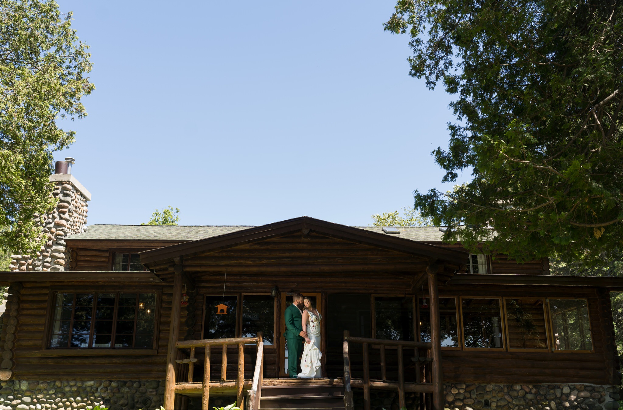 bride and groom pose in a Hubbard Lake cottage