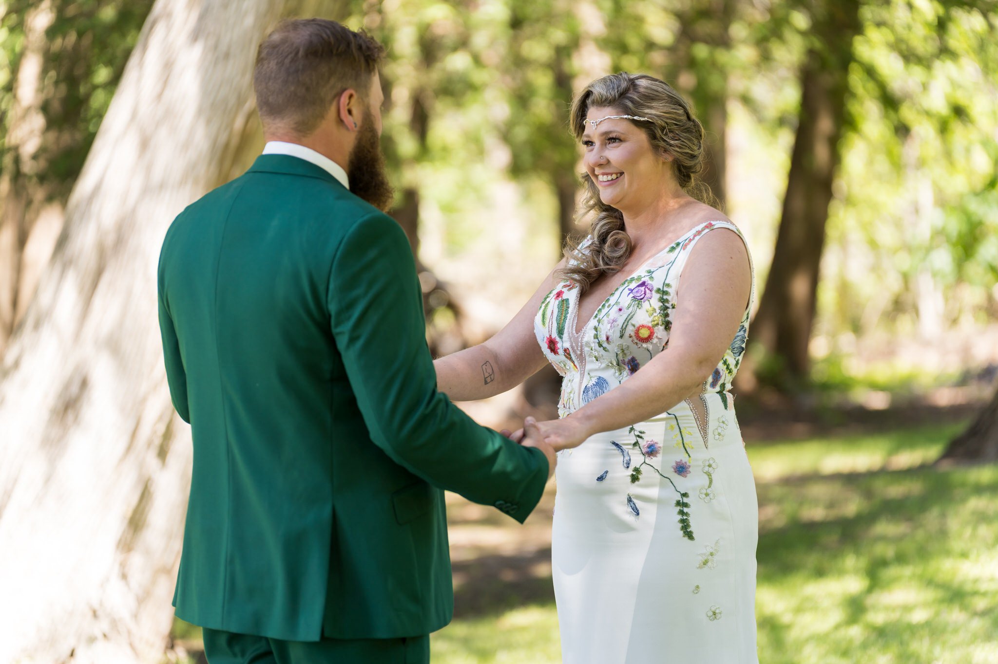bride smiles during her first look on Hubbard Lake