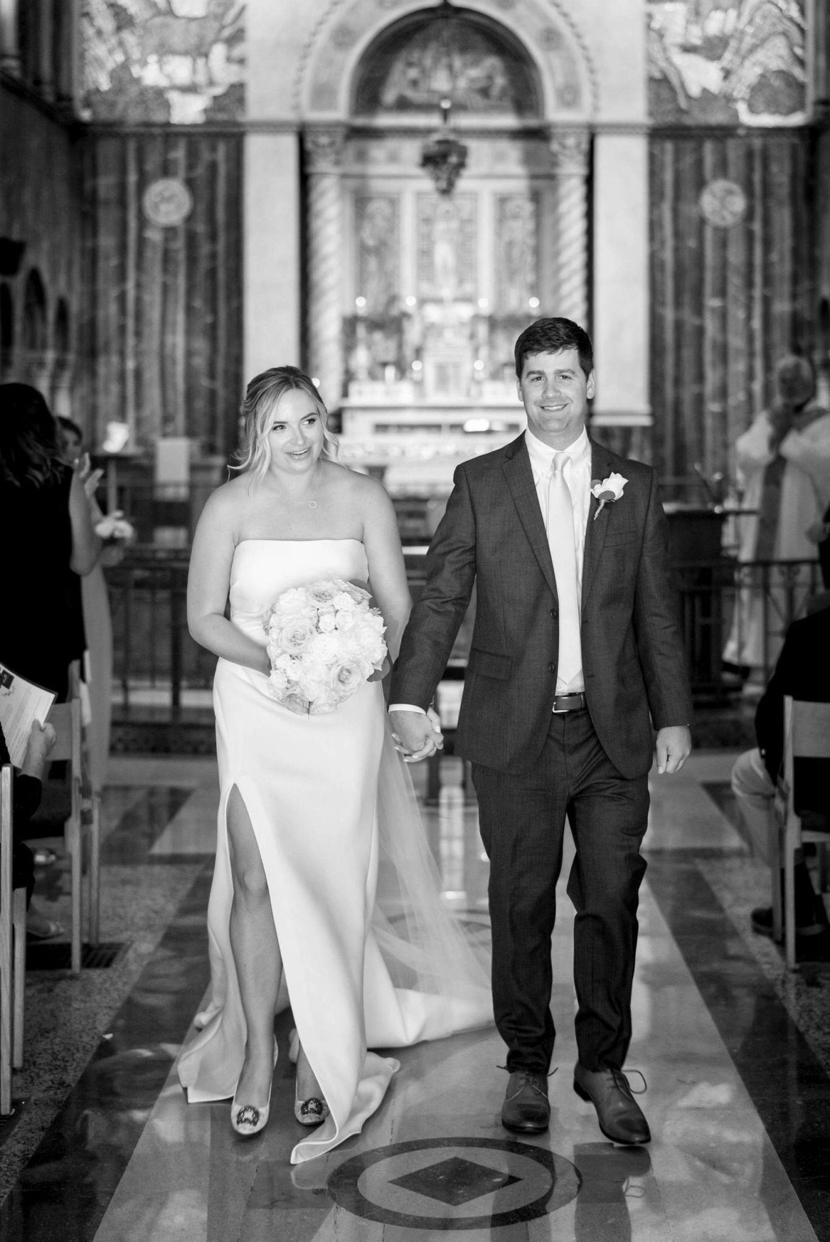 bride and groom walk down the aisle at St. Aloysius Church in Detroit 