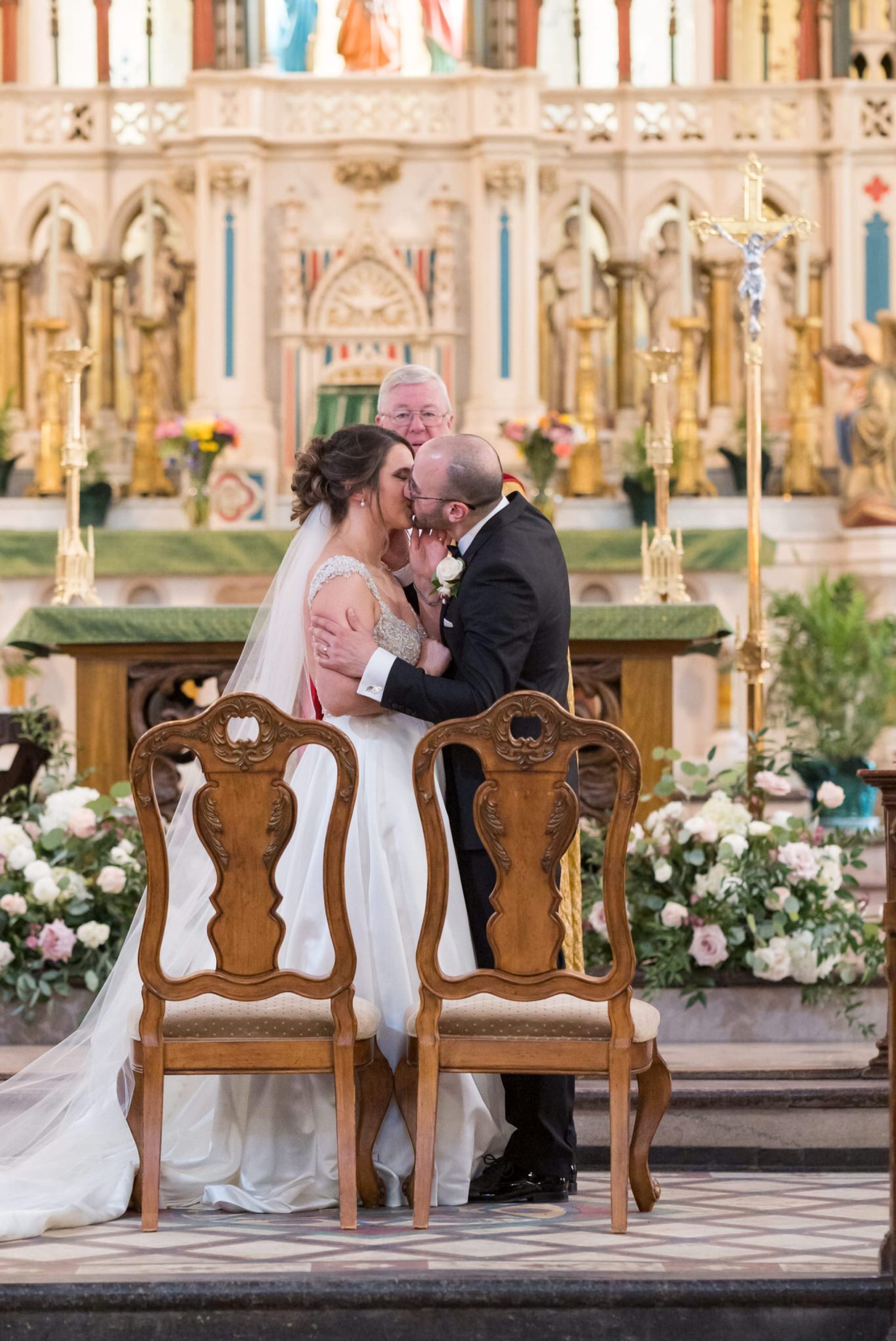 bride and groom kiss at St. Anne de Detroit wedding 
