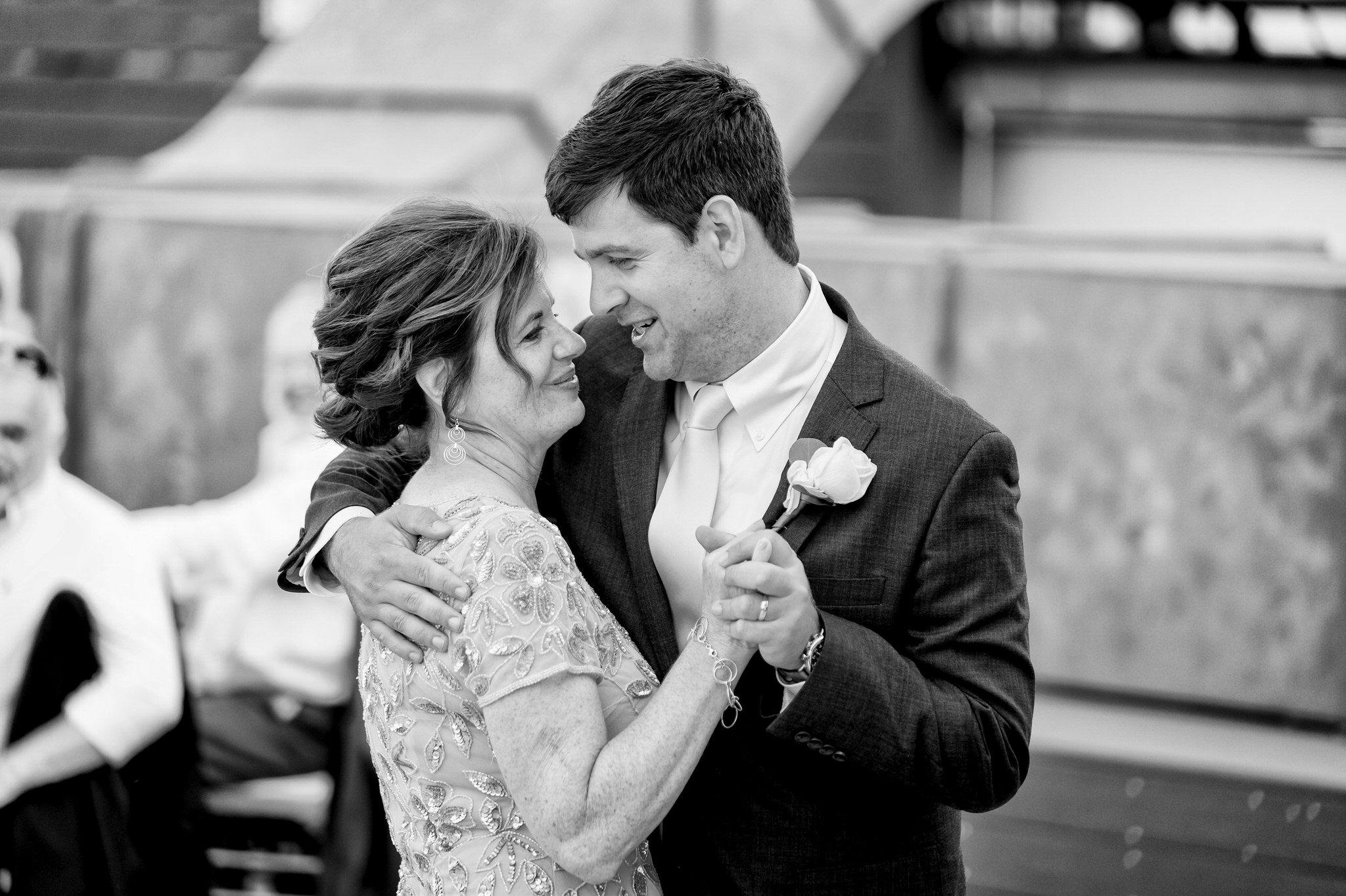 groom and mother dance on a rooftop at a wedding at Detroit Opera House