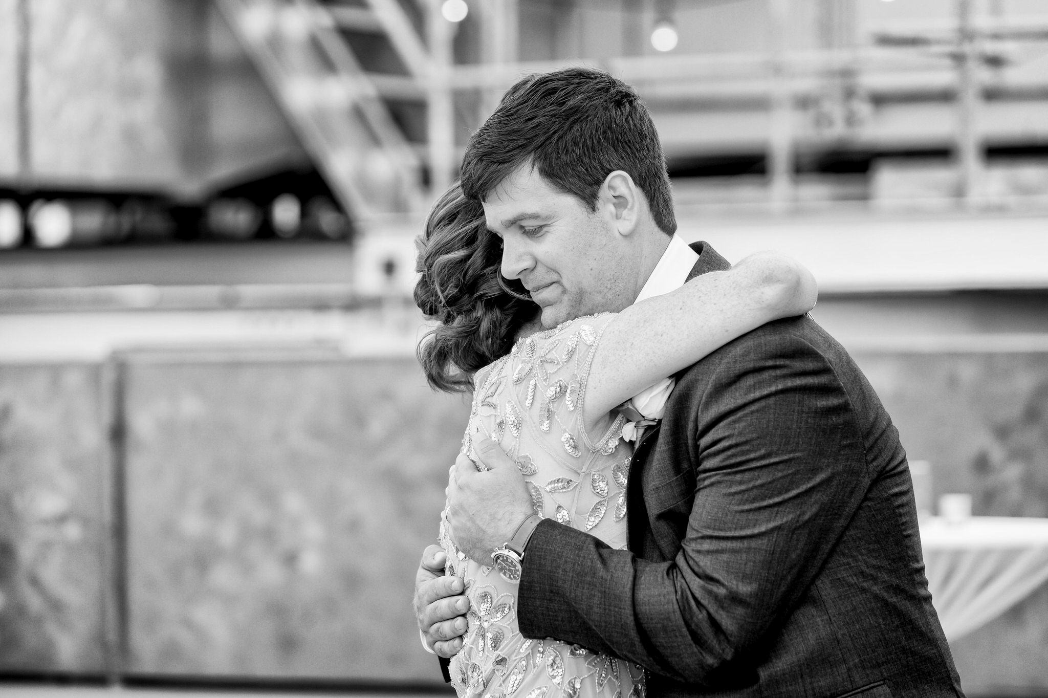 groom and mother hug on a rooftop at a wedding at Detroit Opera House