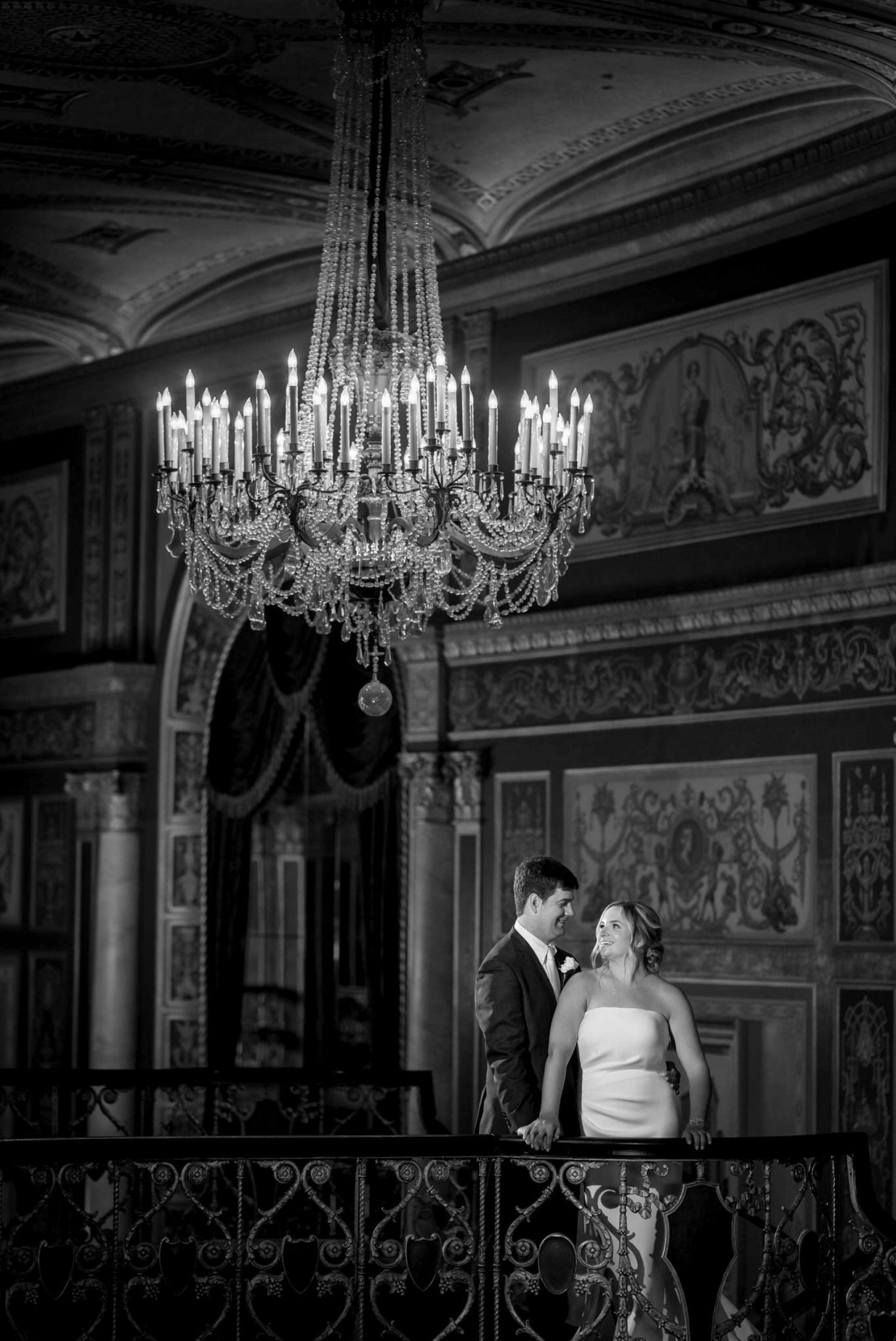 bride and groom under a chandelier at a wedding at Detroit Opera house 