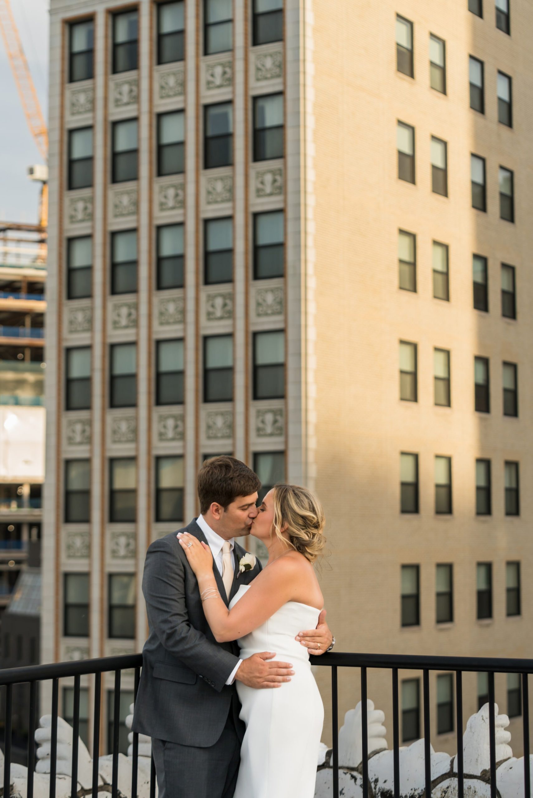 bride and groom kiss on a rooftop at a wedding at Detroit Opera House
