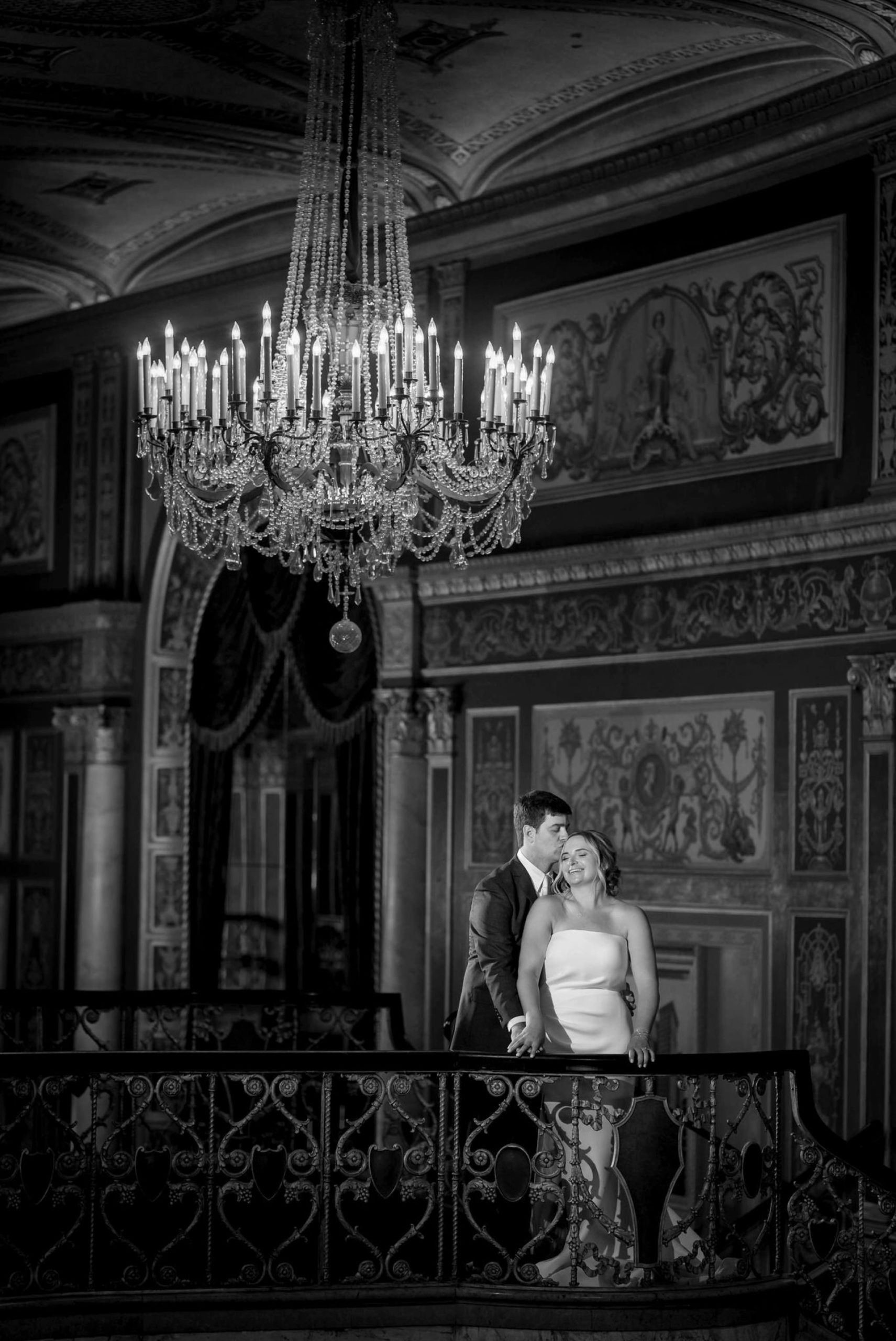 bride and groom under a chandelier at a wedding at Detroit Opera house 