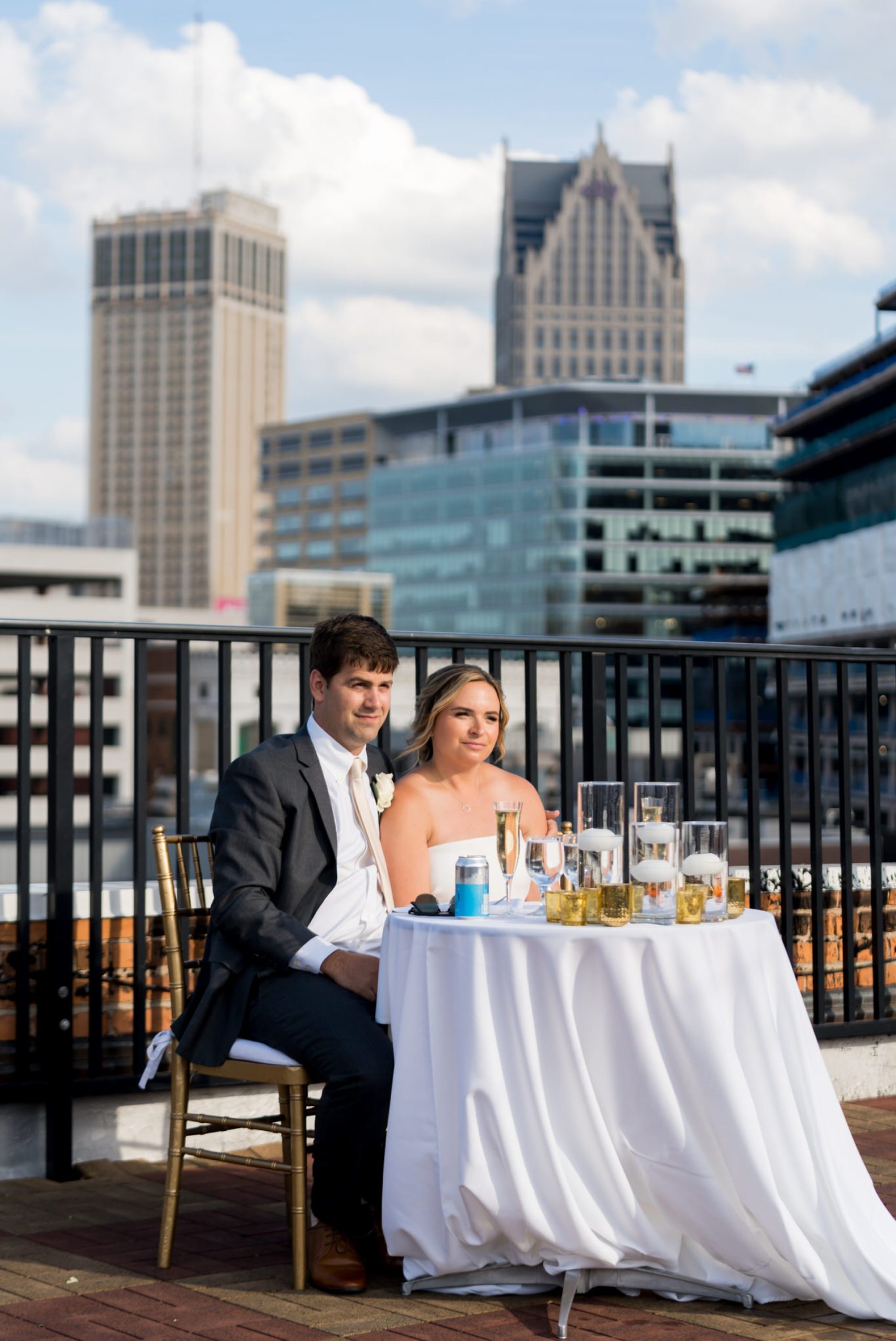 bride and groom listen to speeches at a rooftop wedding at Detroit Opera house 