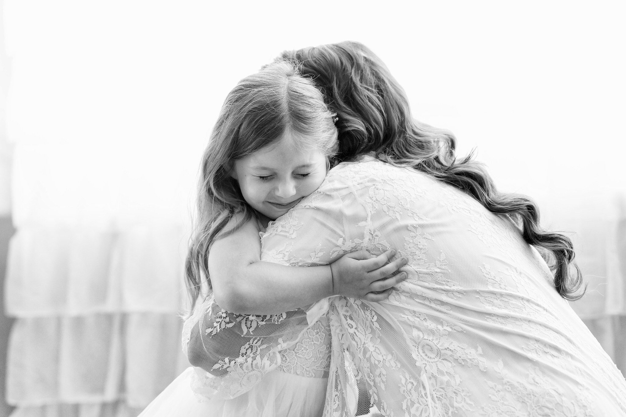 a daughter hugs her mom on her wedding day